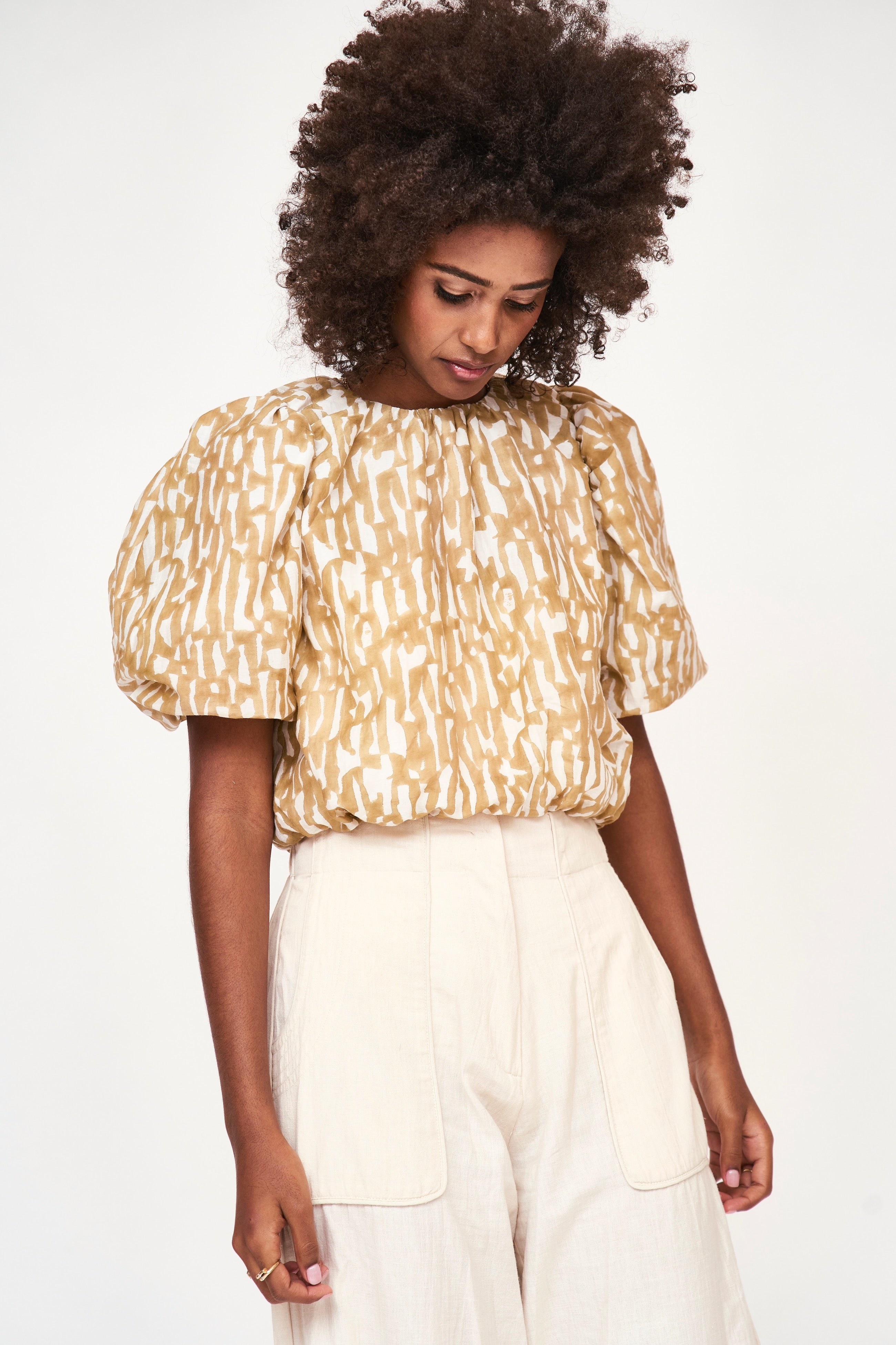 Girl wearing MIRTH women's ballon sleeve andaman cropped top in brown driftwood cotton silk