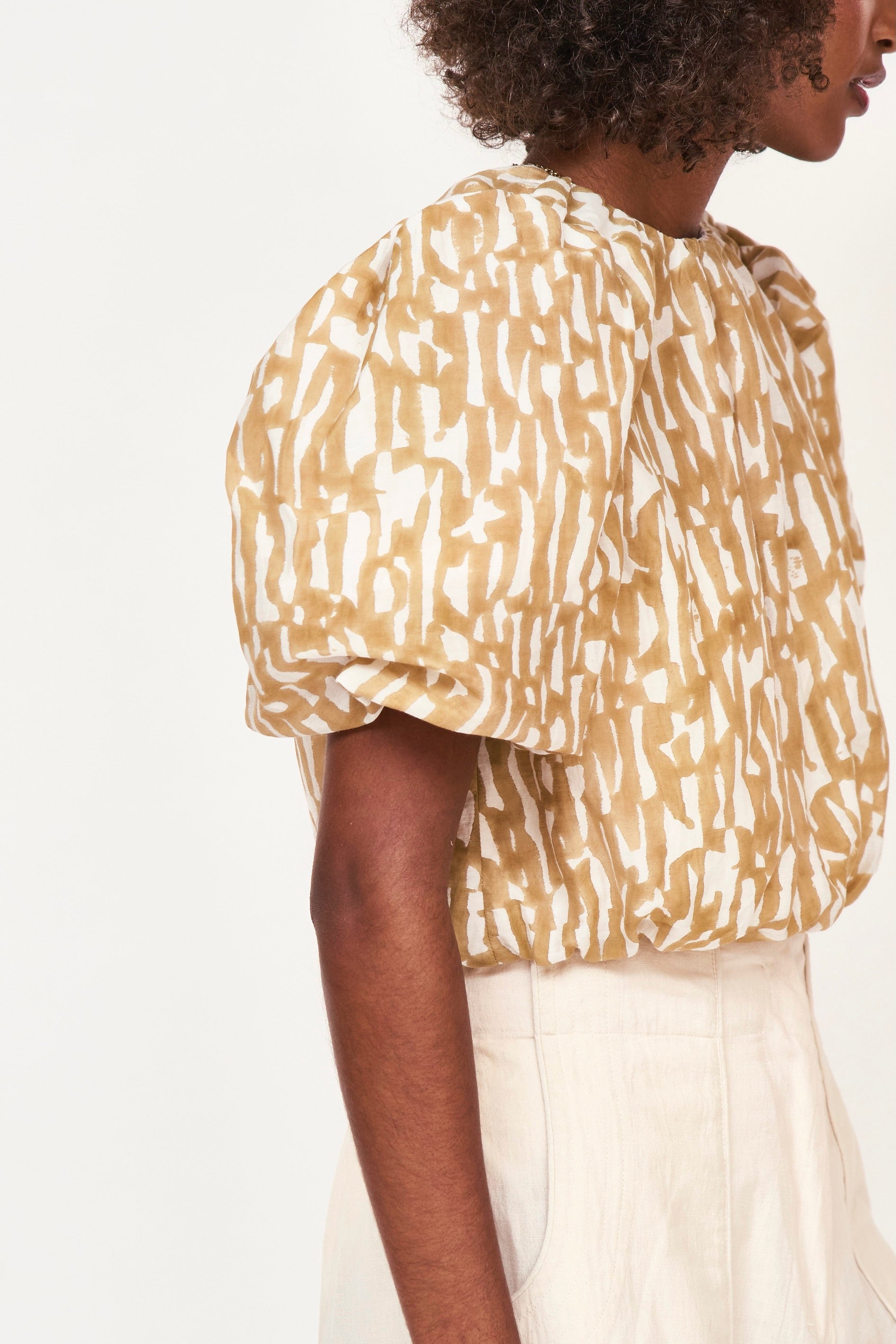 Girl wearing MIRTH women's ballon sleeve andaman cropped top in brown driftwood cotton silk