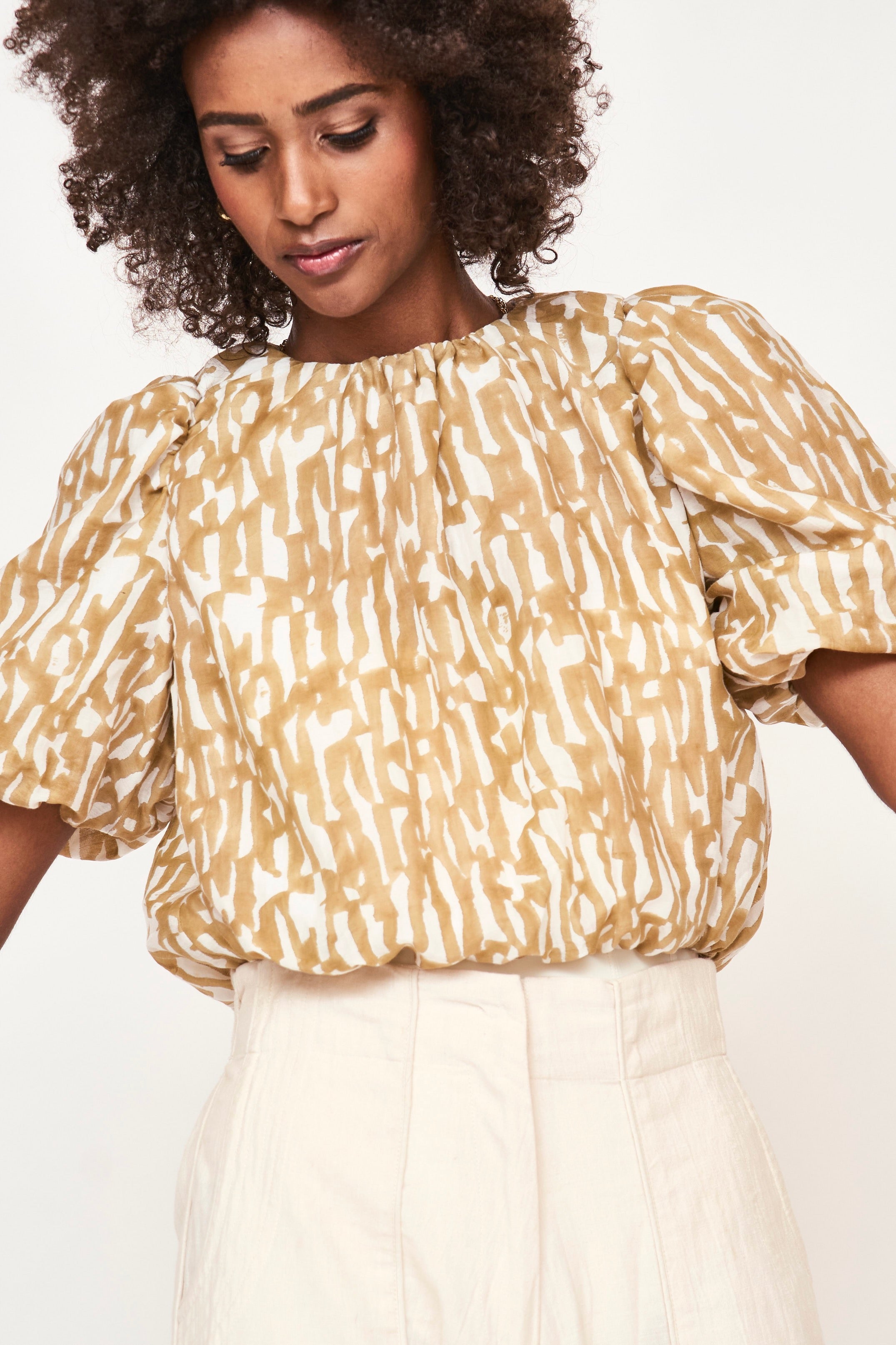 Girl wearing MIRTH women's ballon sleeve andaman cropped top in brown driftwood cotton silk