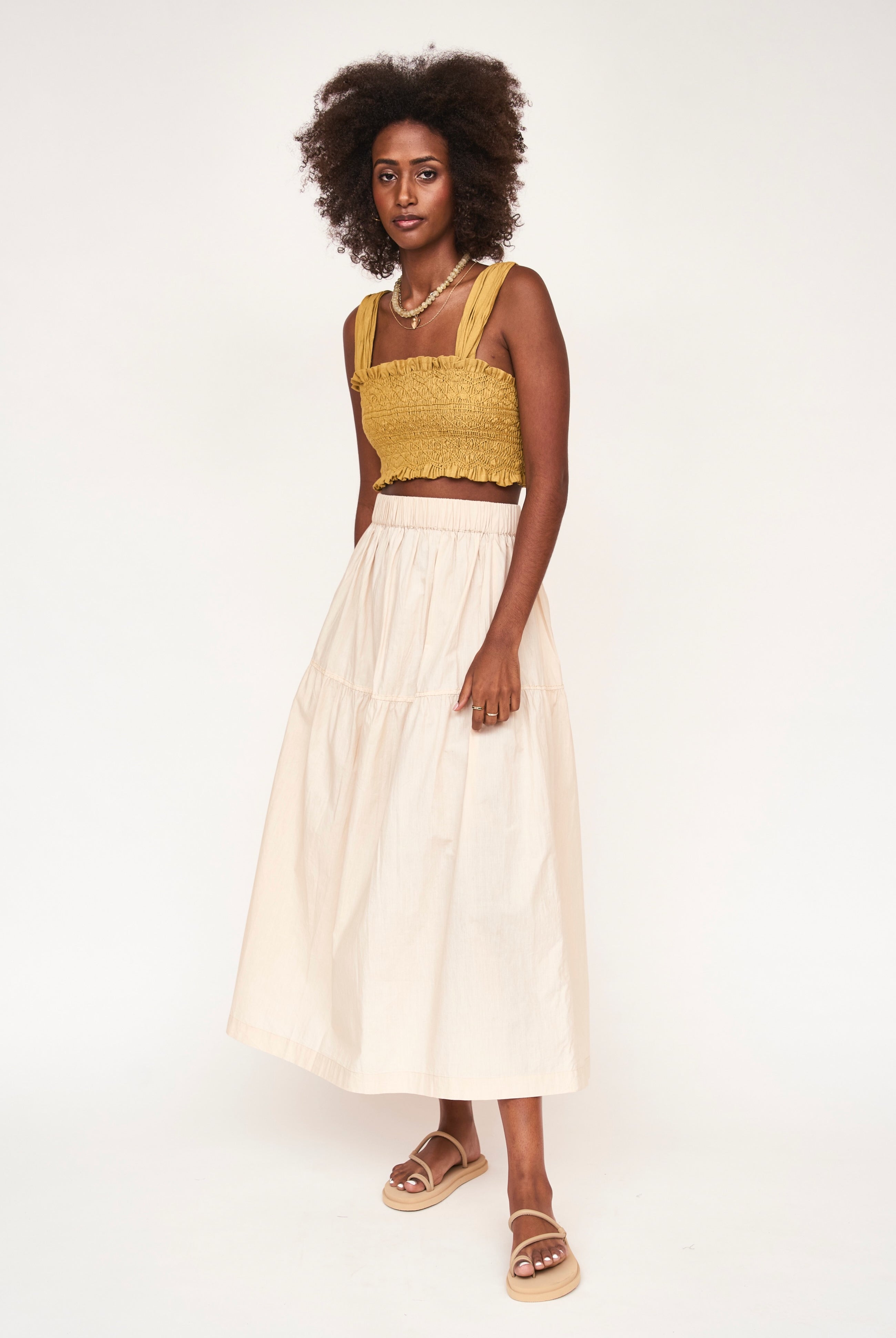 Girl wearing MIRTH women's elastic waist tiered brighton long skirt in parchment cream cotton poplin