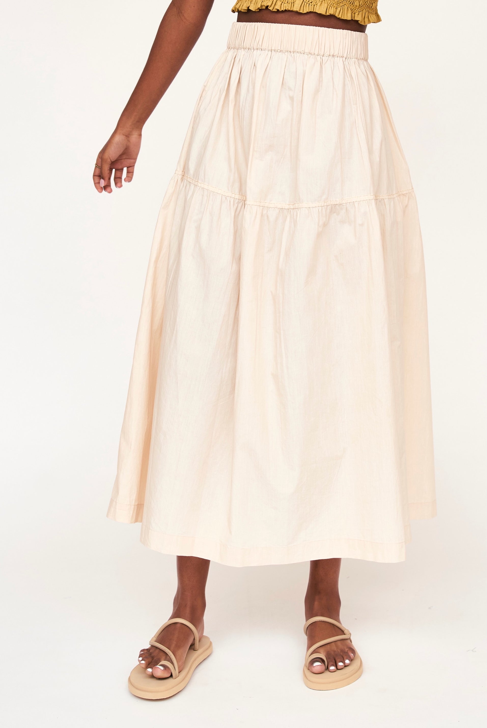 Girl wearing MIRTH women's elastic waist tiered brighton long skirt in parchment cream cotton poplin