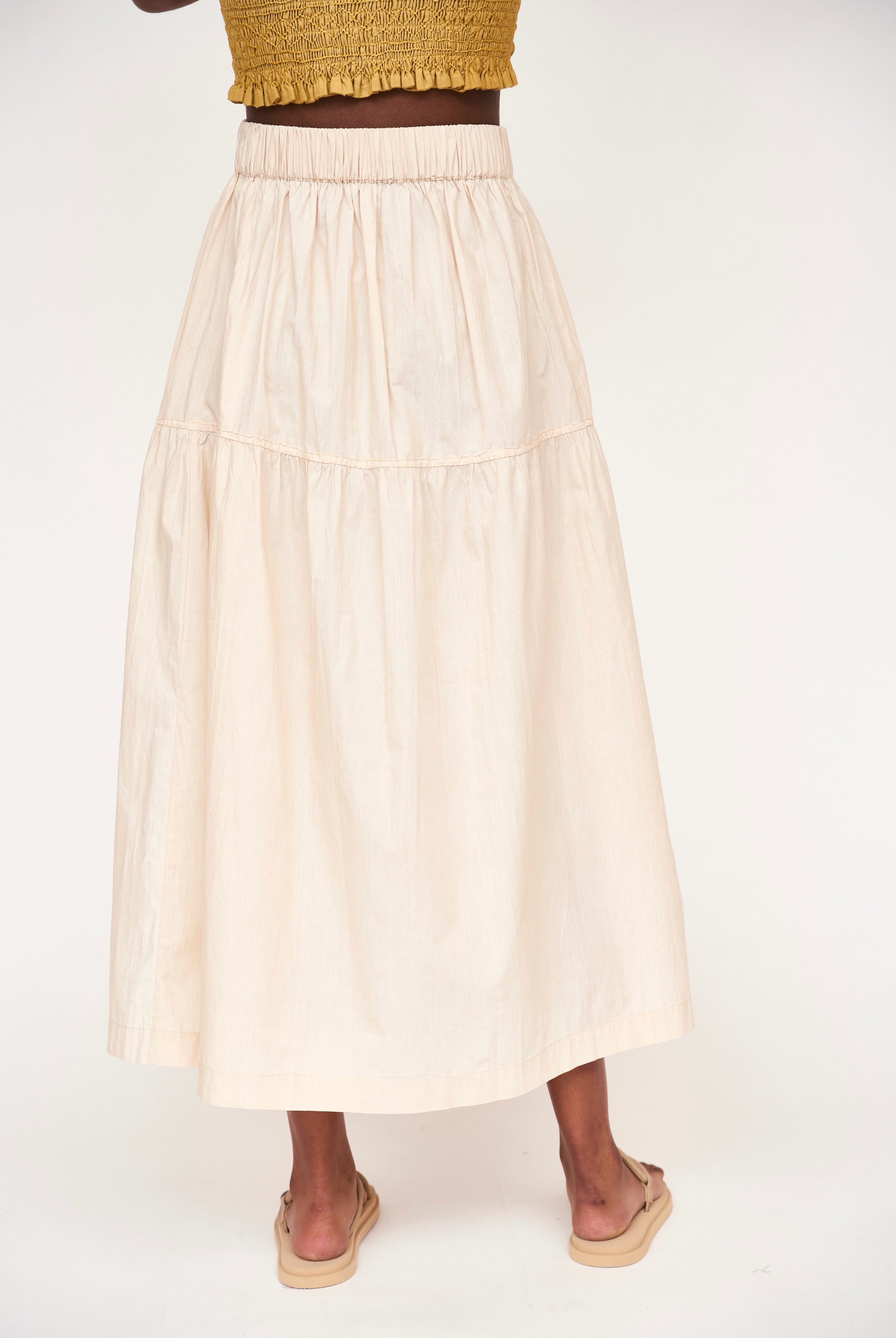 Girl wearing MIRTH women's elastic waist tiered brighton long skirt in parchment cream cotton poplin