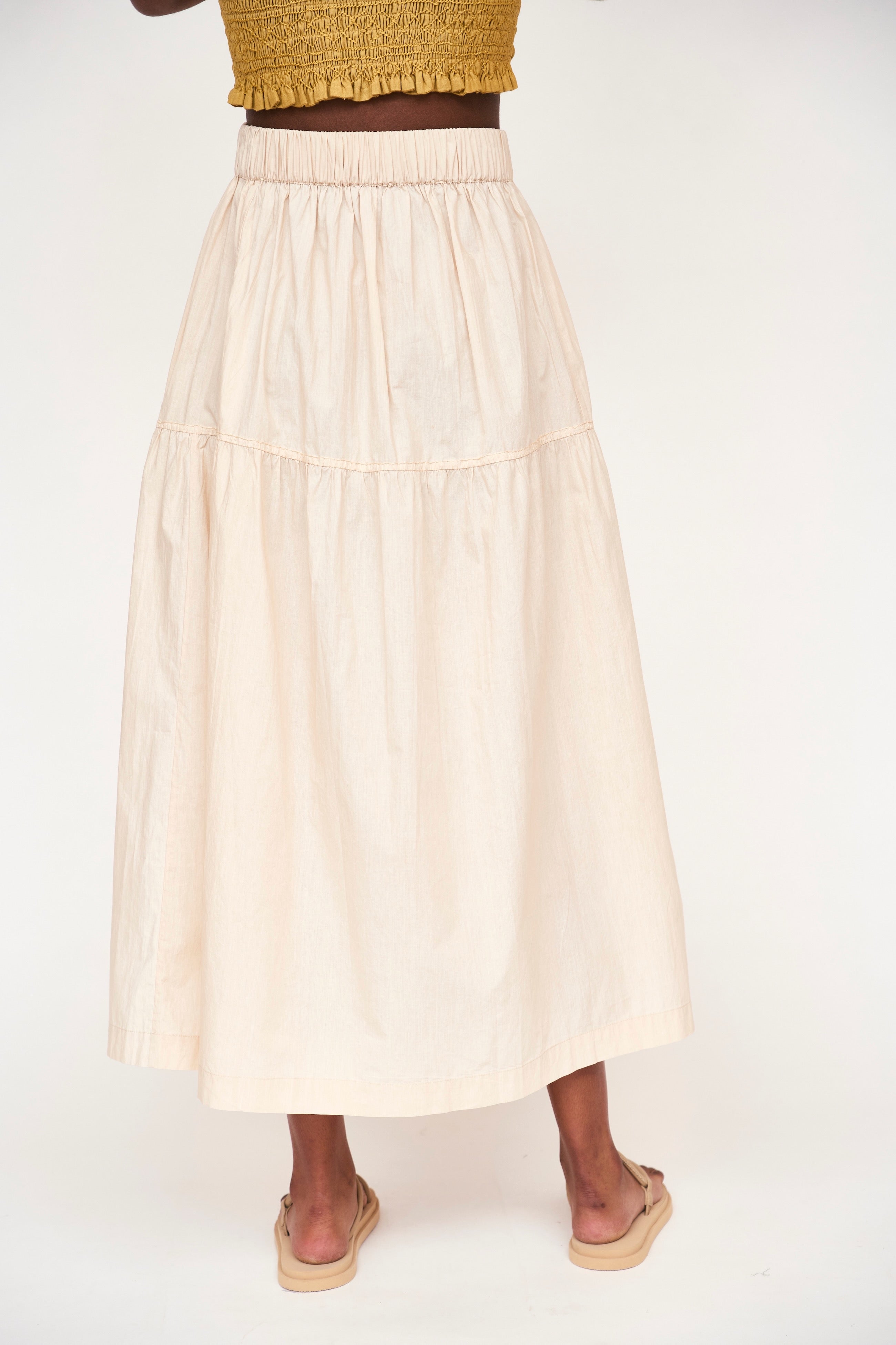 Girl wearing MIRTH women's elastic waist tiered brighton long skirt in parchment cream cotton poplin