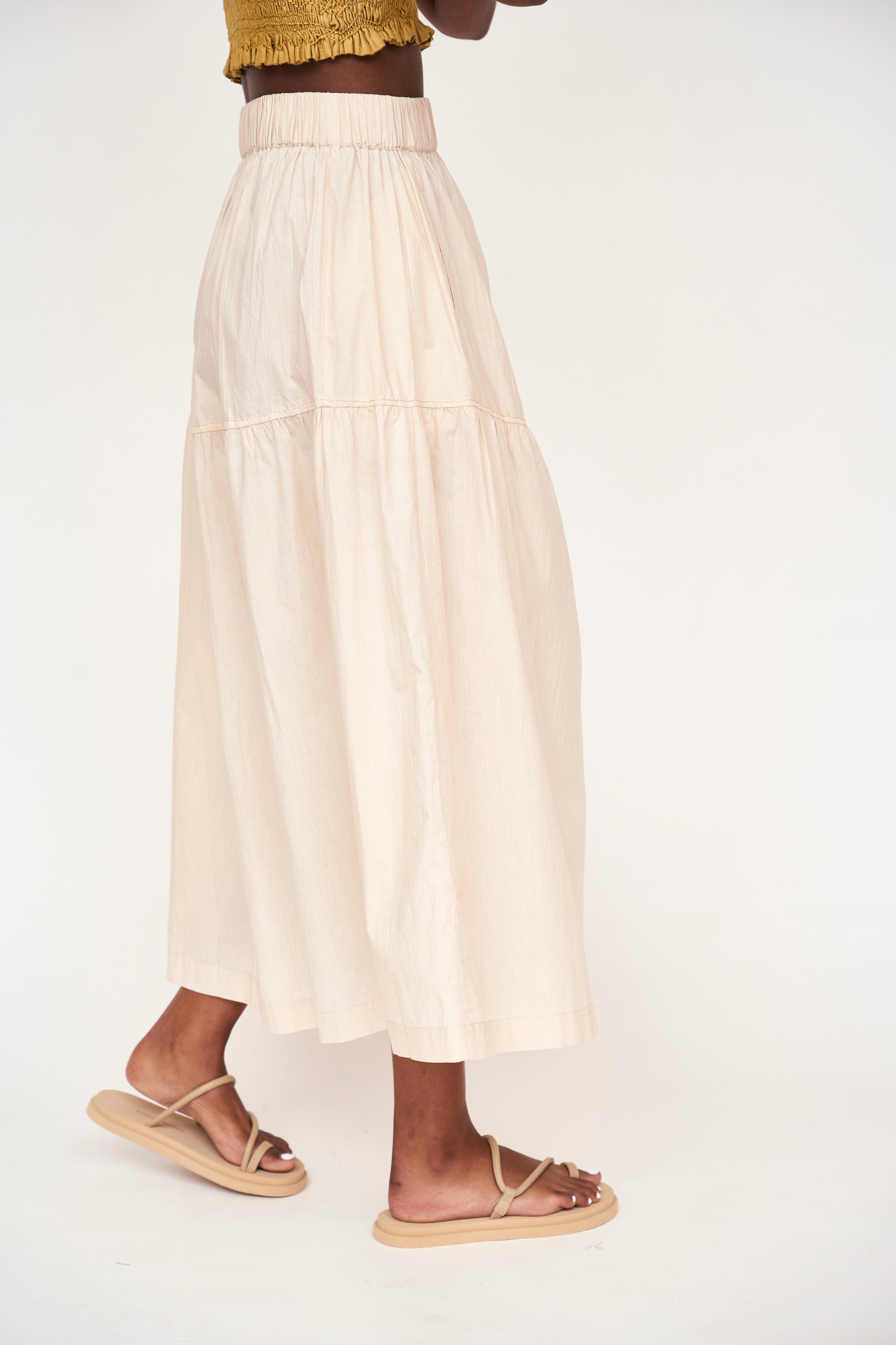 Girl wearing MIRTH women's elastic waist tiered brighton long skirt in parchment cream cotton poplin