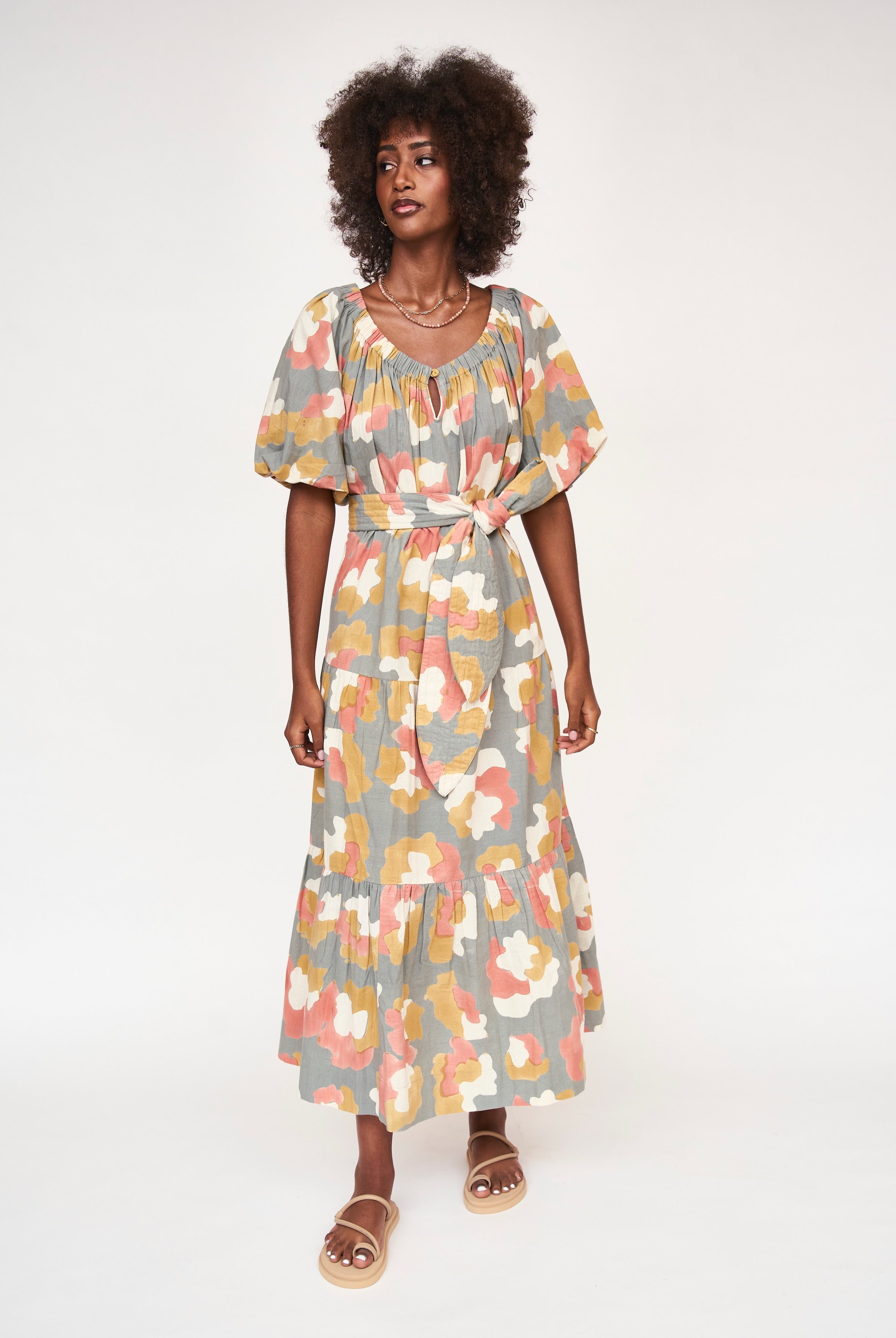 Girl wearing MIRTH women's long tiered short sleeve capri maxi dress in waterlily grey floral cotton