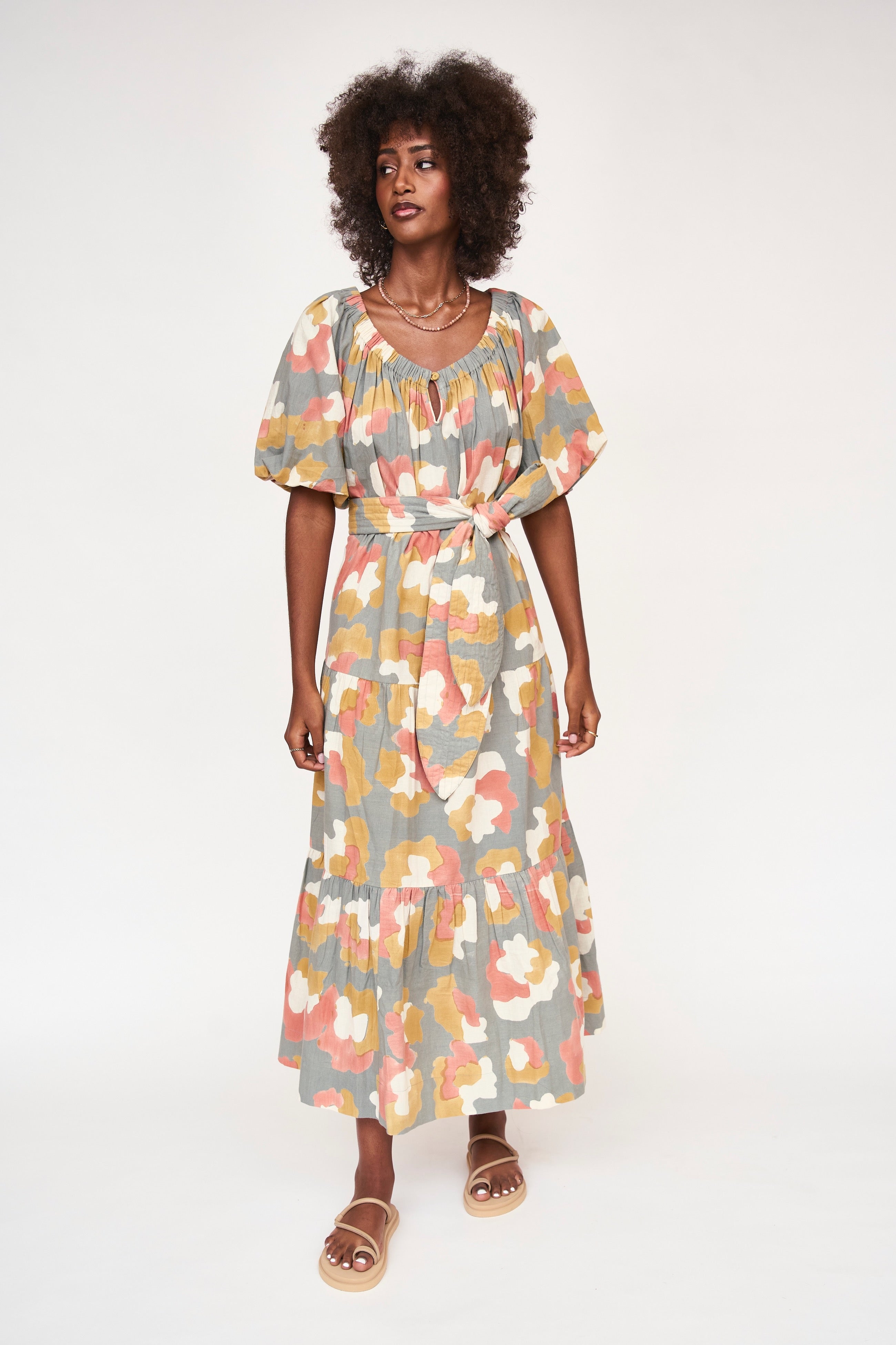 Girl wearing MIRTH women's long tiered short sleeve capri maxi dress in waterlily grey floral cotton