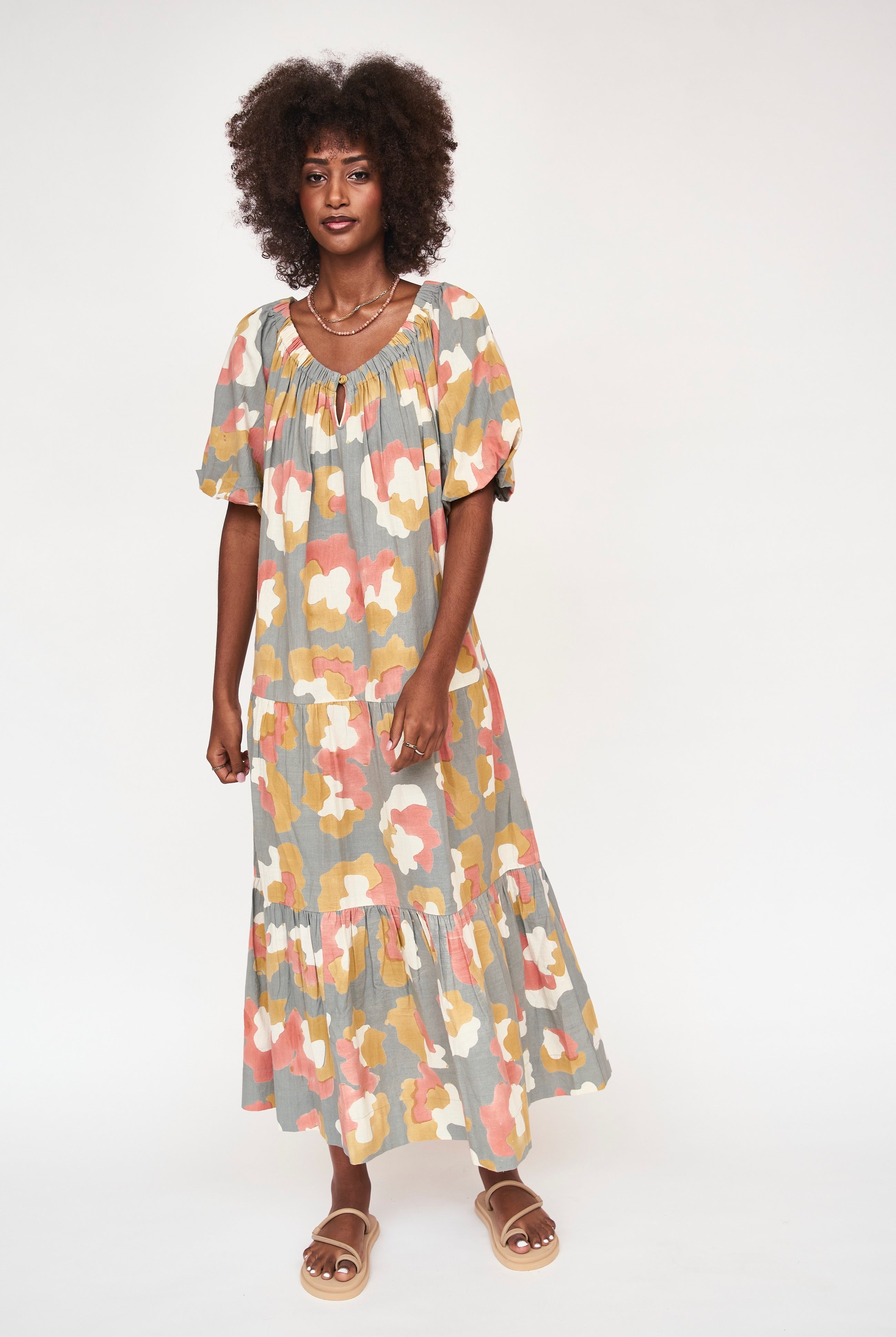 Girl wearing MIRTH women's long tiered short sleeve capri maxi dress in waterlily grey floral cotton