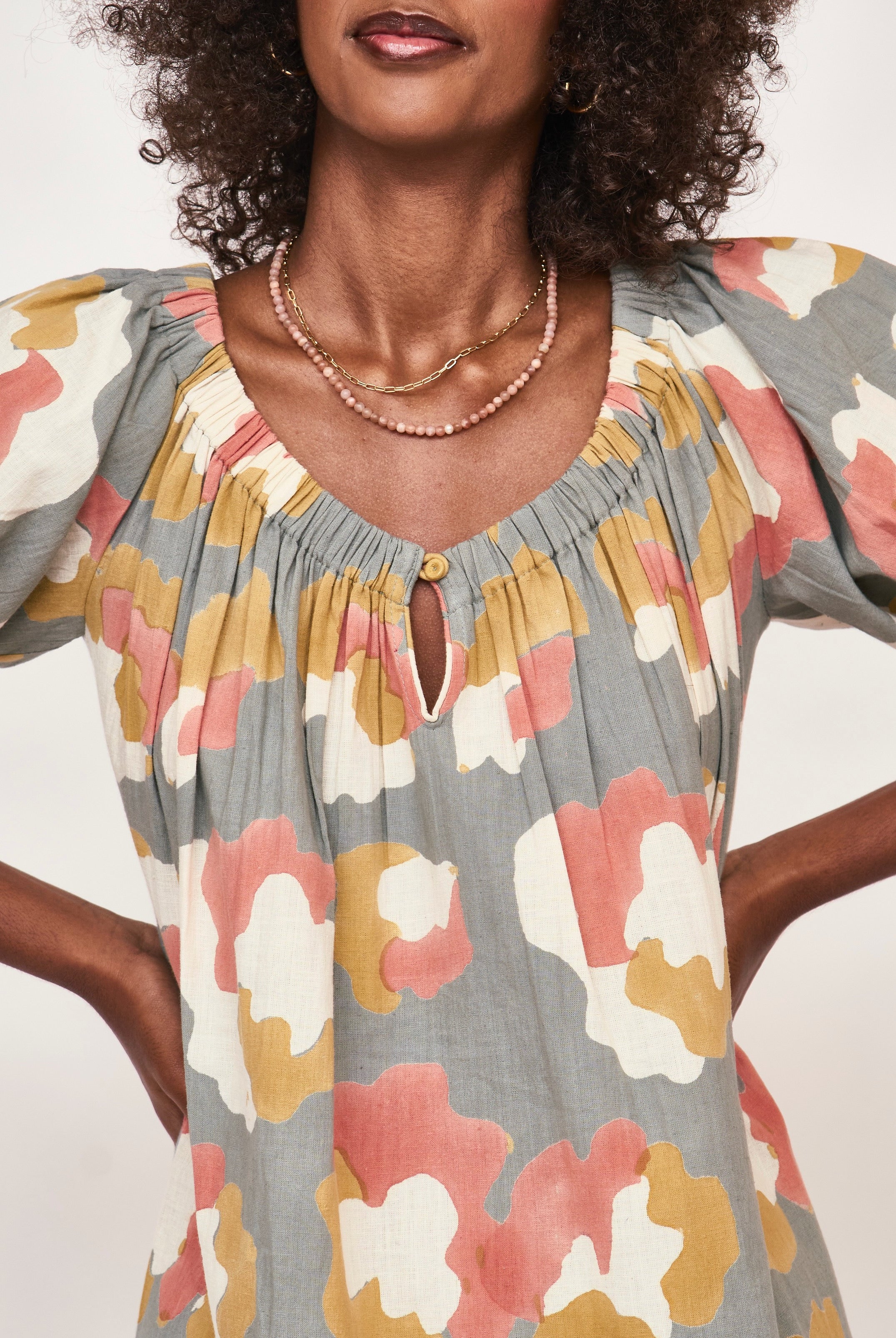 Girl wearing MIRTH women's long tiered short sleeve capri maxi dress in waterlily grey floral cotton