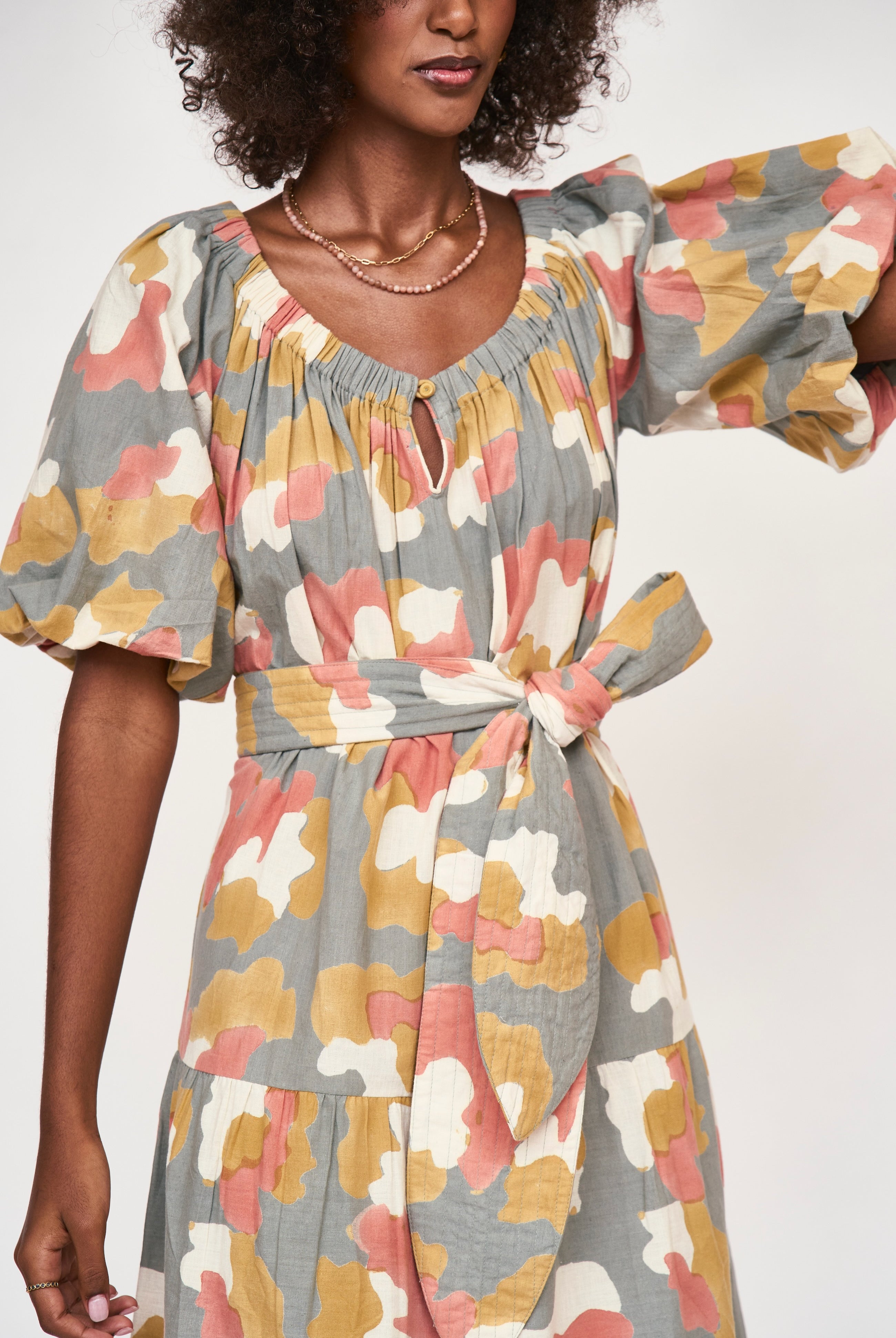 Girl wearing MIRTH women's long tiered short sleeve capri maxi dress in waterlily grey floral cotton