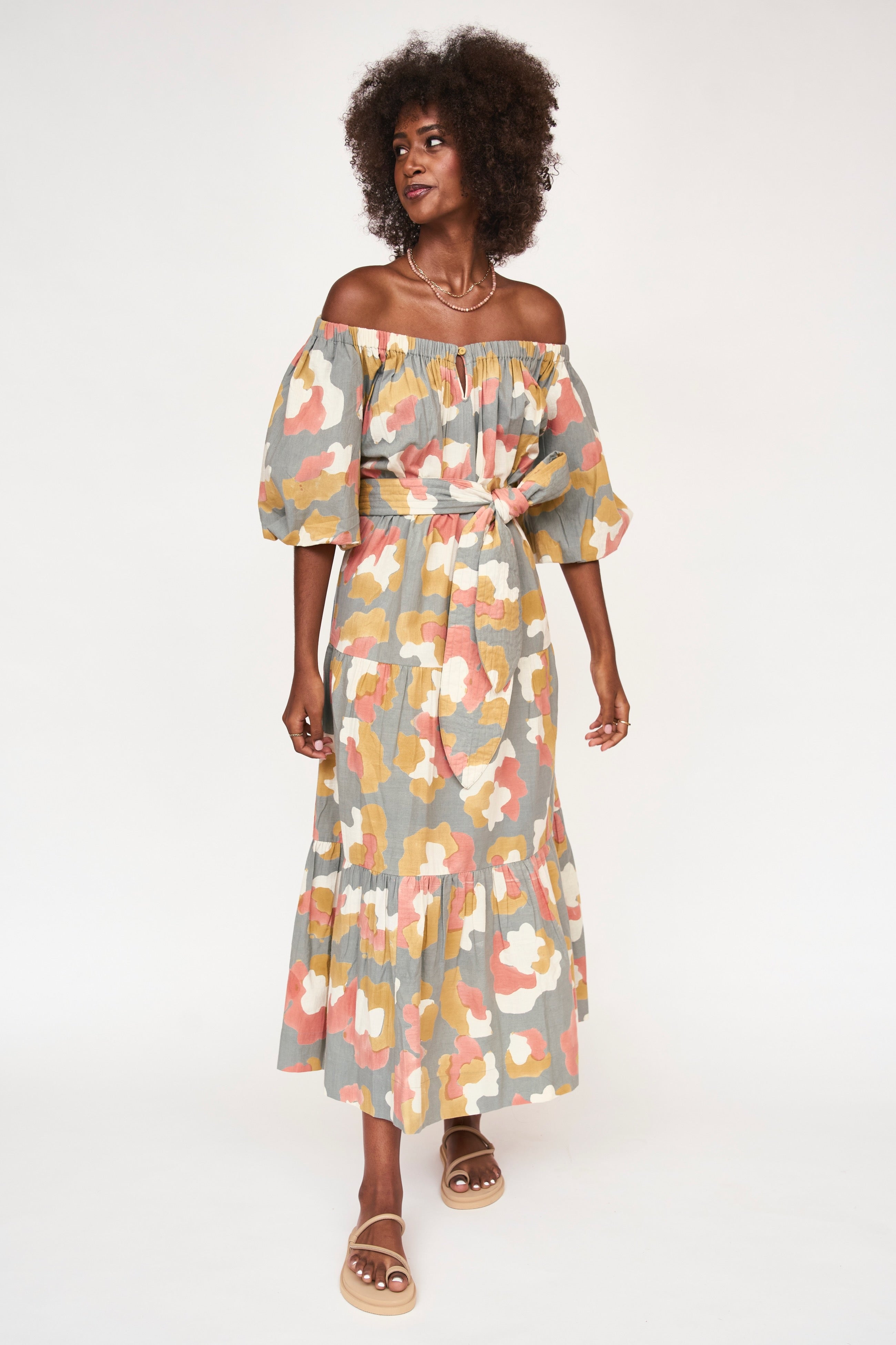 Girl wearing MIRTH women's long tiered short sleeve capri maxi dress in waterlily grey floral cotton