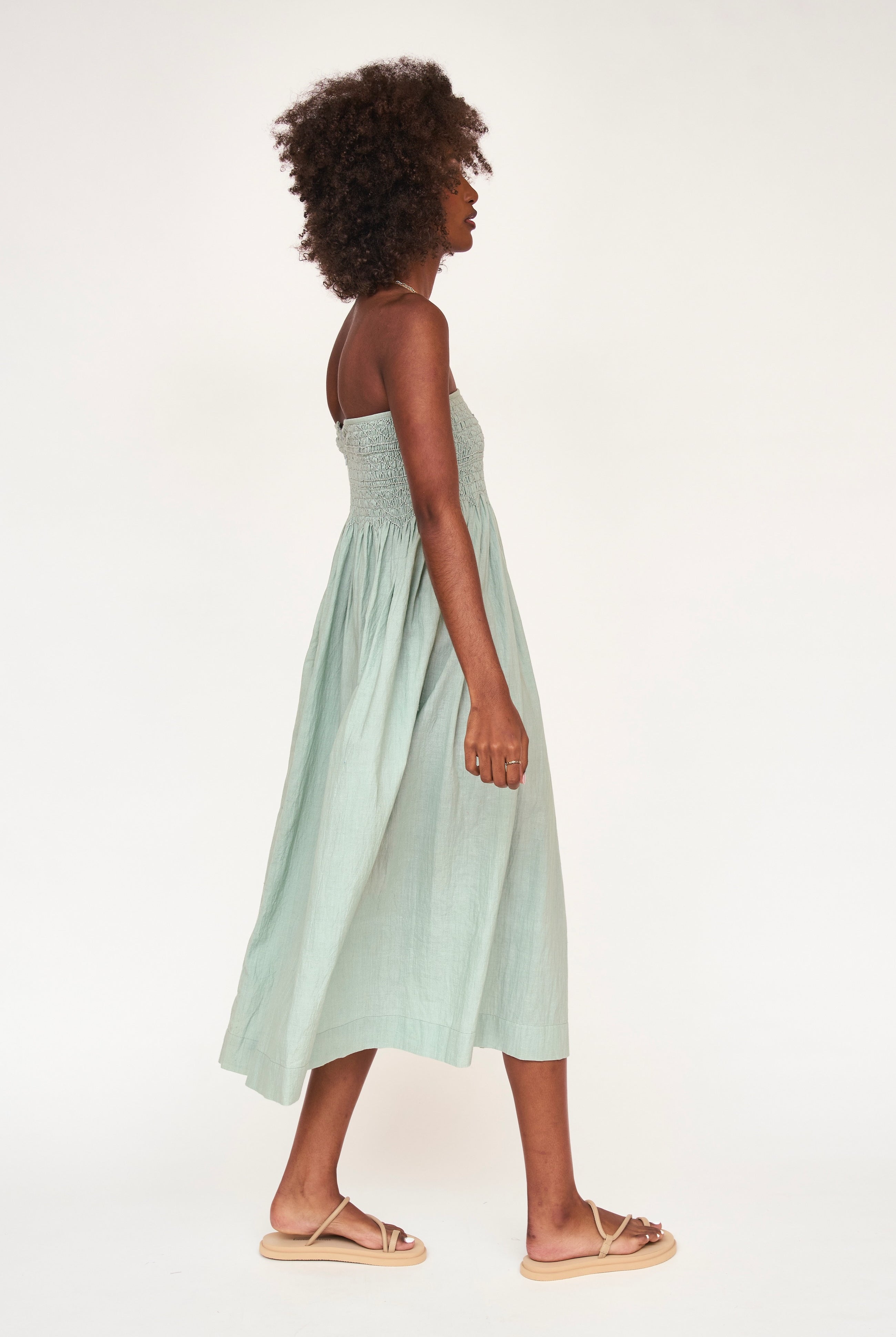 Girl wearing MIRTH women's smocked elastic sleeveless georgia midi dress in frost blue cotton