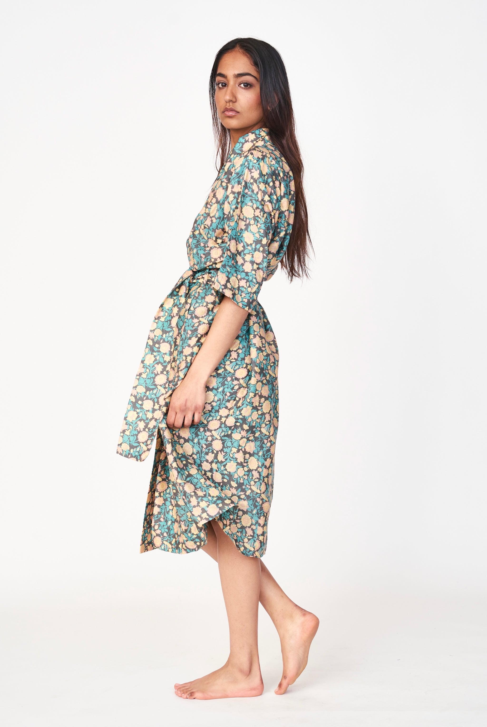 Girl wearing MIRTH women's laos cotton bathrobe in onyx bloom floral cotton silk