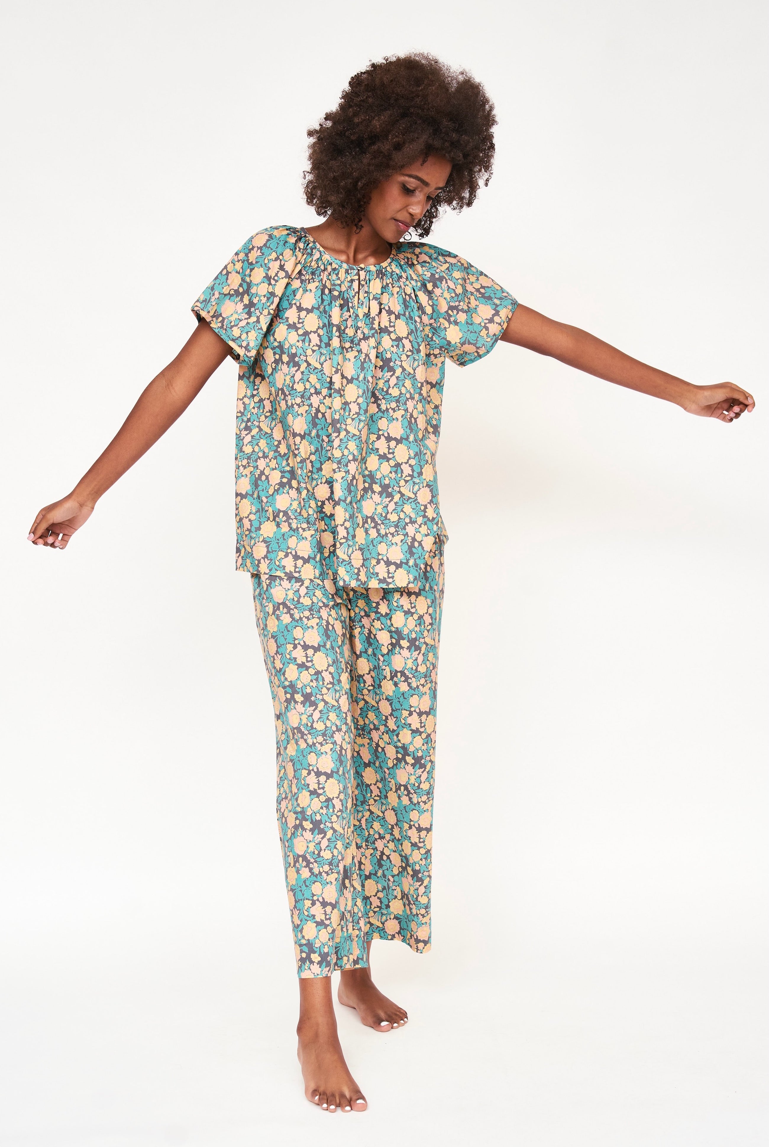 Girl wearing MIRTH women's short sleeve pajama pant set in onyx bloom floral cotton