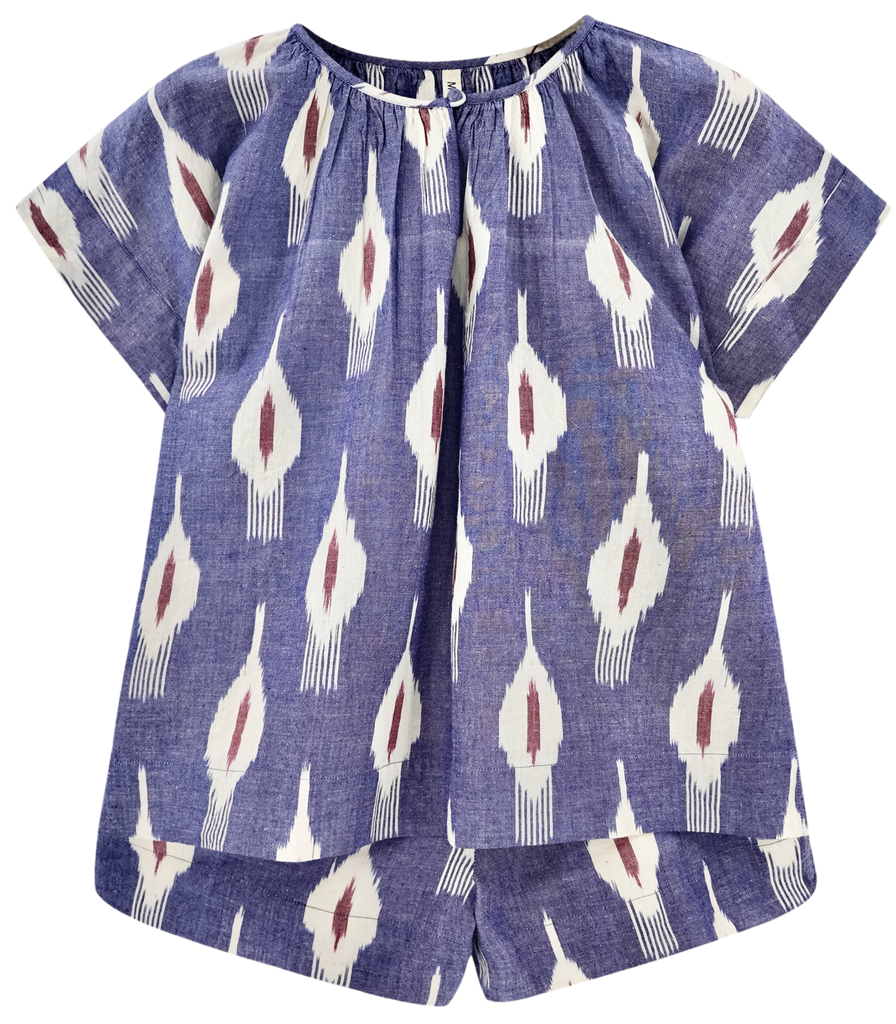Girl wearing MIRTH women's short sleeve pajama short set in nauticak ikat blue cotton