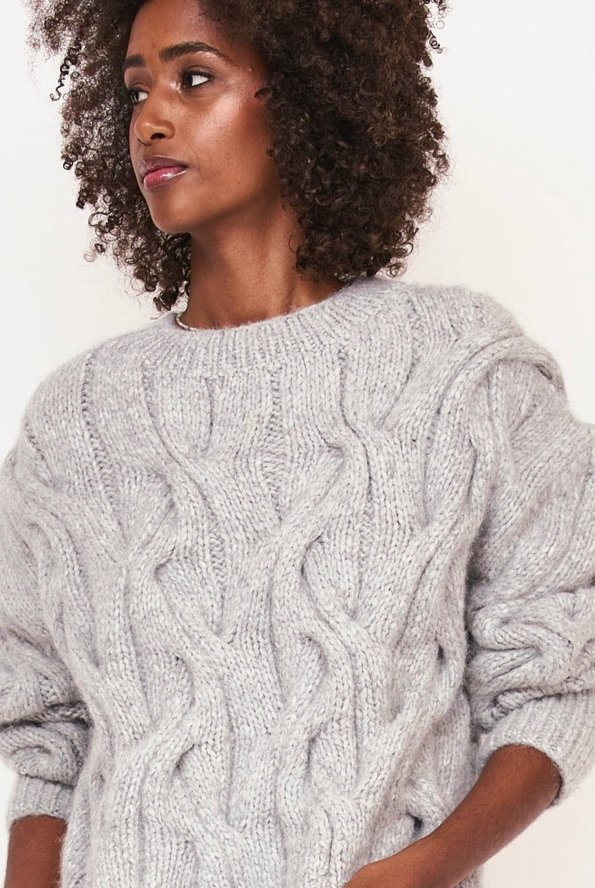 Girl wearing MIRTH women's handknit cortina cable pullover sweater in dove grey wool