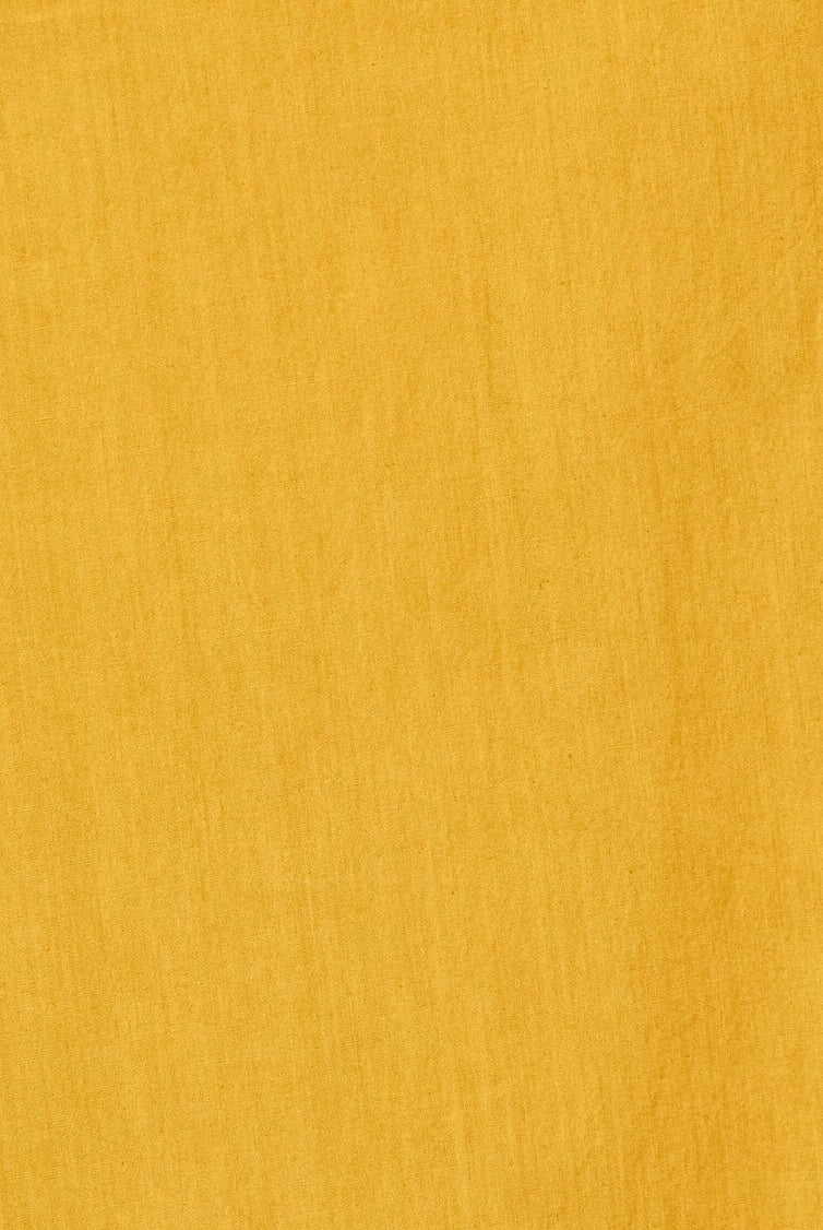 Girl wearing MIRTH women's wide leg elastic track shorts in gilded yellow cotton