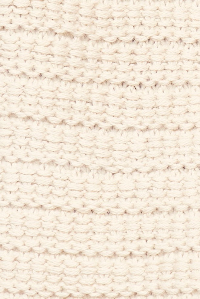 Girl wearing MIRTH women's sleeveless carmel open side knit sweater vest in snow white alpaca wool