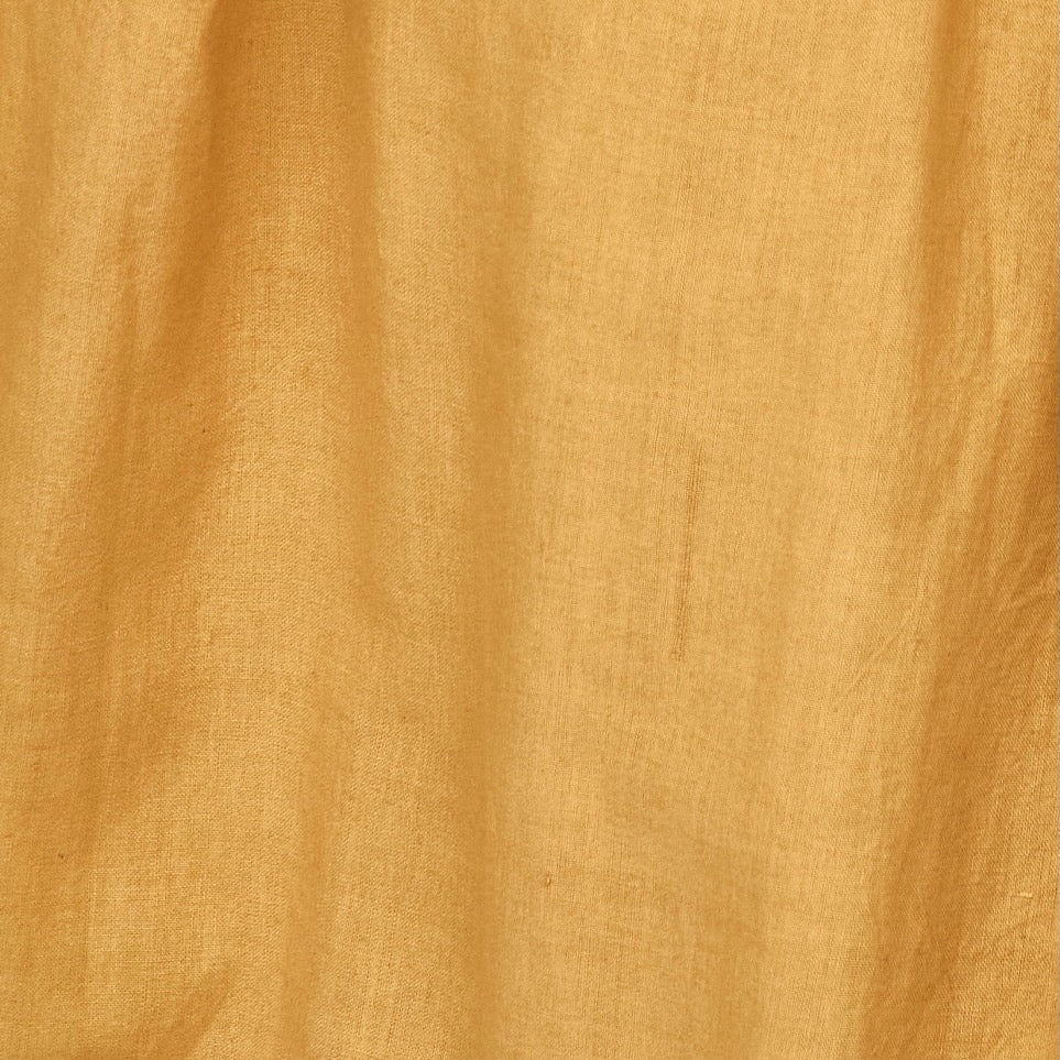 Girl wearing MIRTH women's smocked elastic waist savannah skirt set in yellow gilded cotton