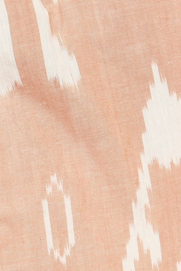 Girl wearing MIRTH women's wide leg elastic track shorts in conch ikat pink cotton