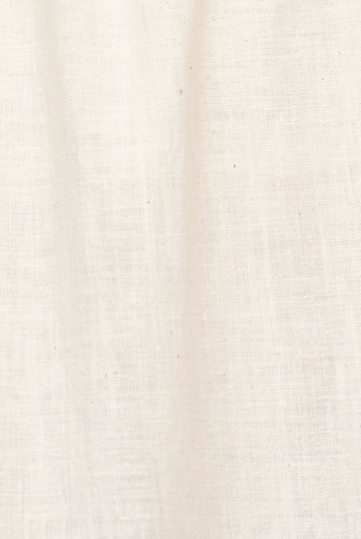 Girl wearing MIRTH women's v neck layered pintuck sleeveless long belted laguna dress in parchment cream cotton