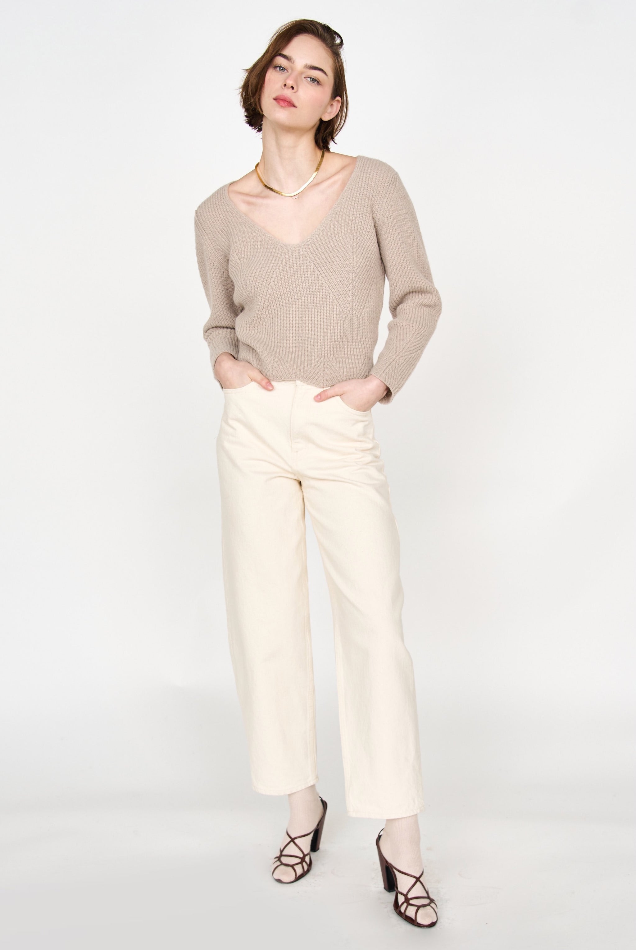 Girl wearing MIRTH women's knit v neck bellagio sweater in taupe brown wool