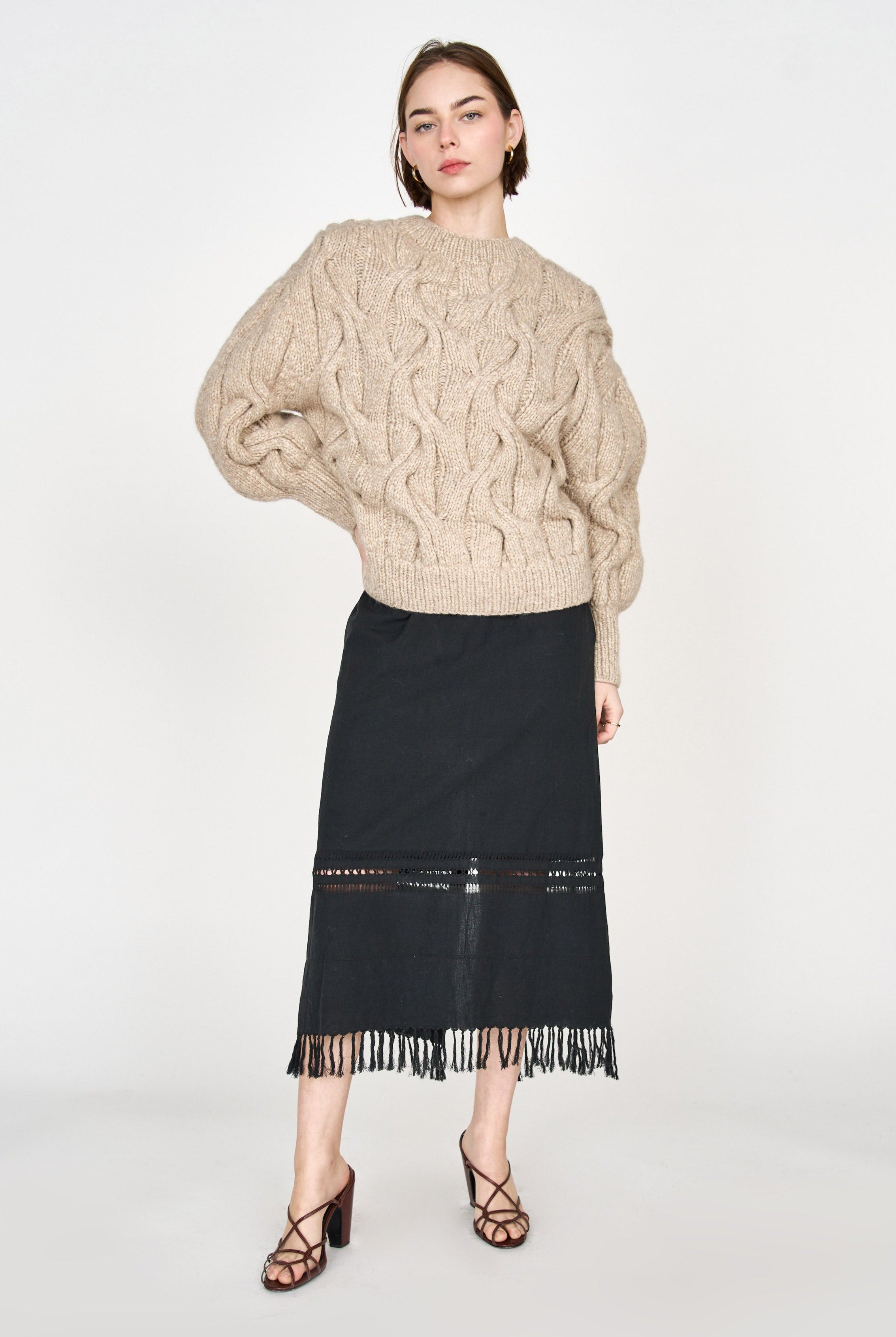 Girl wearing MIRTH women's midi fringe cutout lombok skirt in black cotton