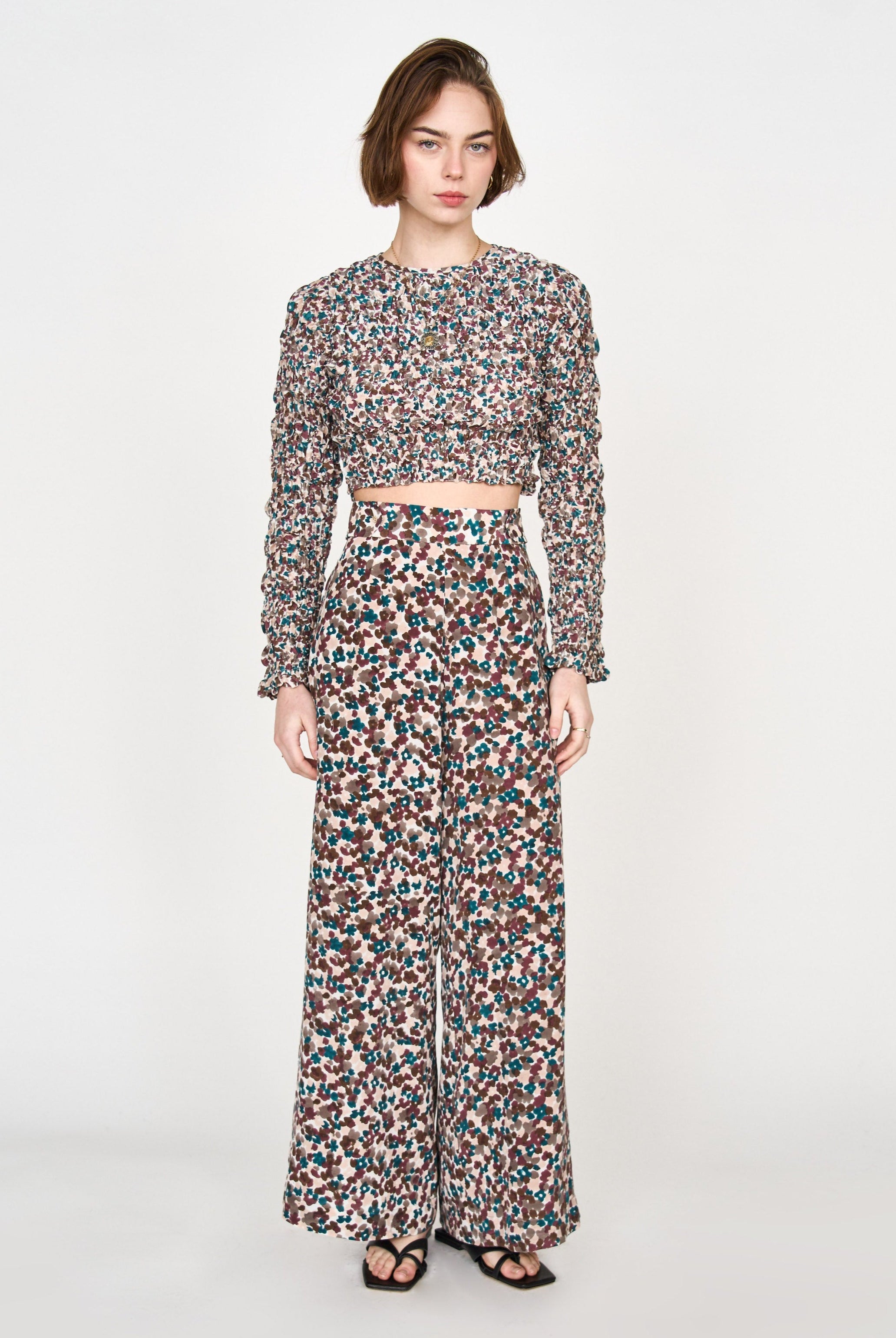 Girl wearing MIRTH women's long flowy riga trouser pant in purple brown amaryllis silk