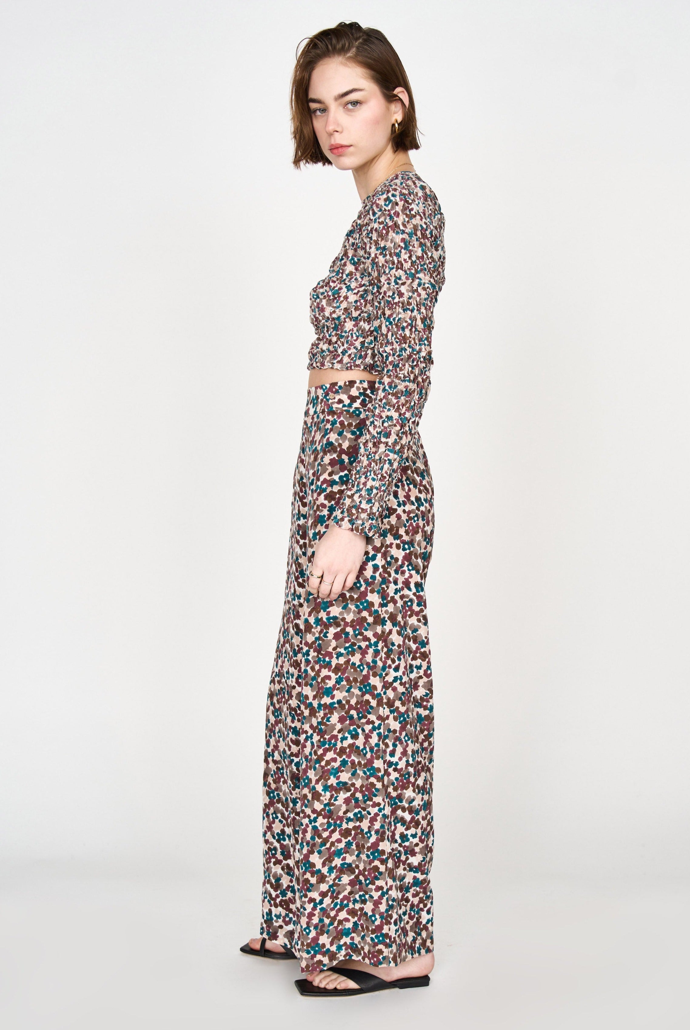 Girl wearing MIRTH women's long flowy riga trouser pant in purple brown amaryllis silk