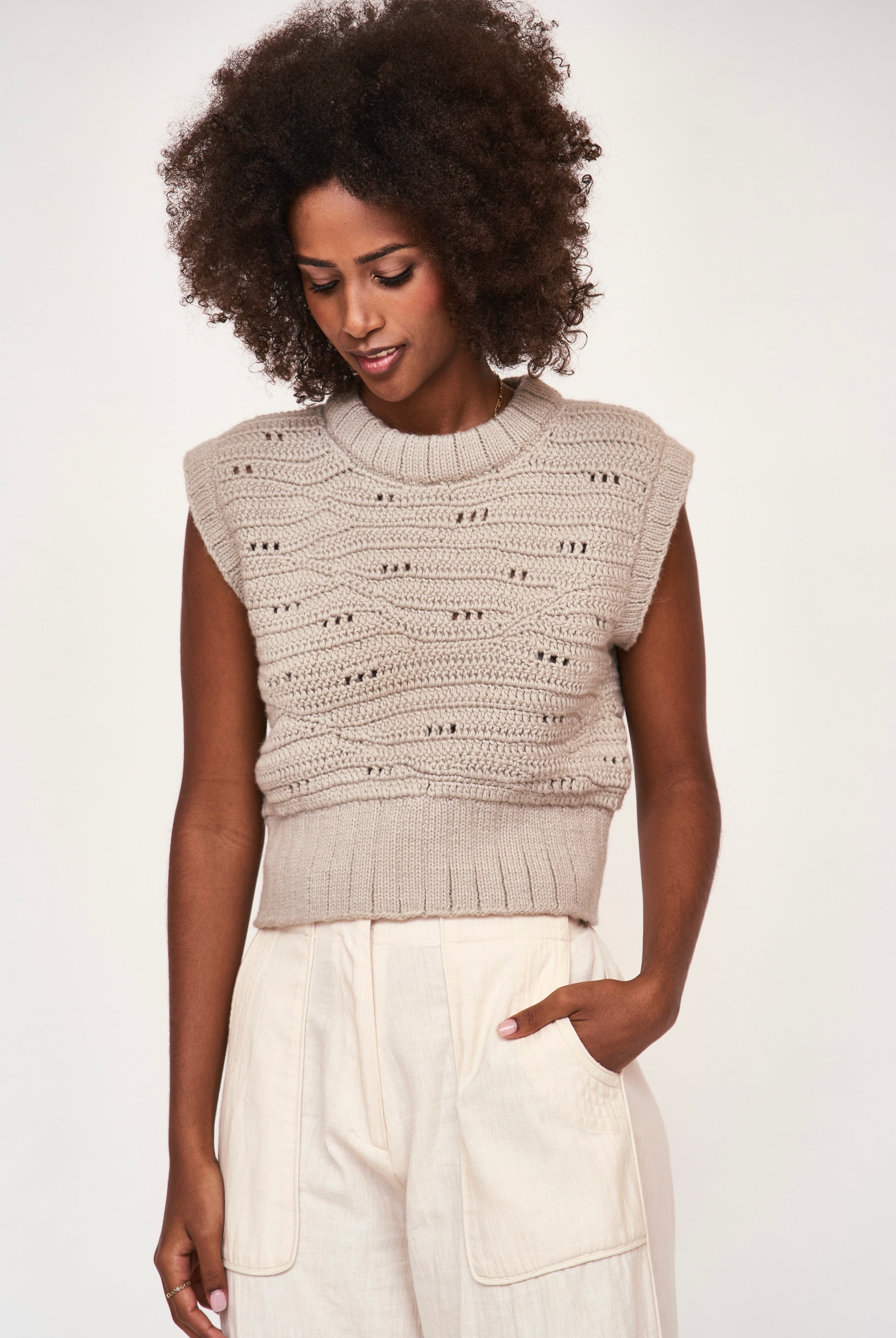 Girl wearing MIRTH women's hand crocheted marin sweater vest in koala grey alpaca wool