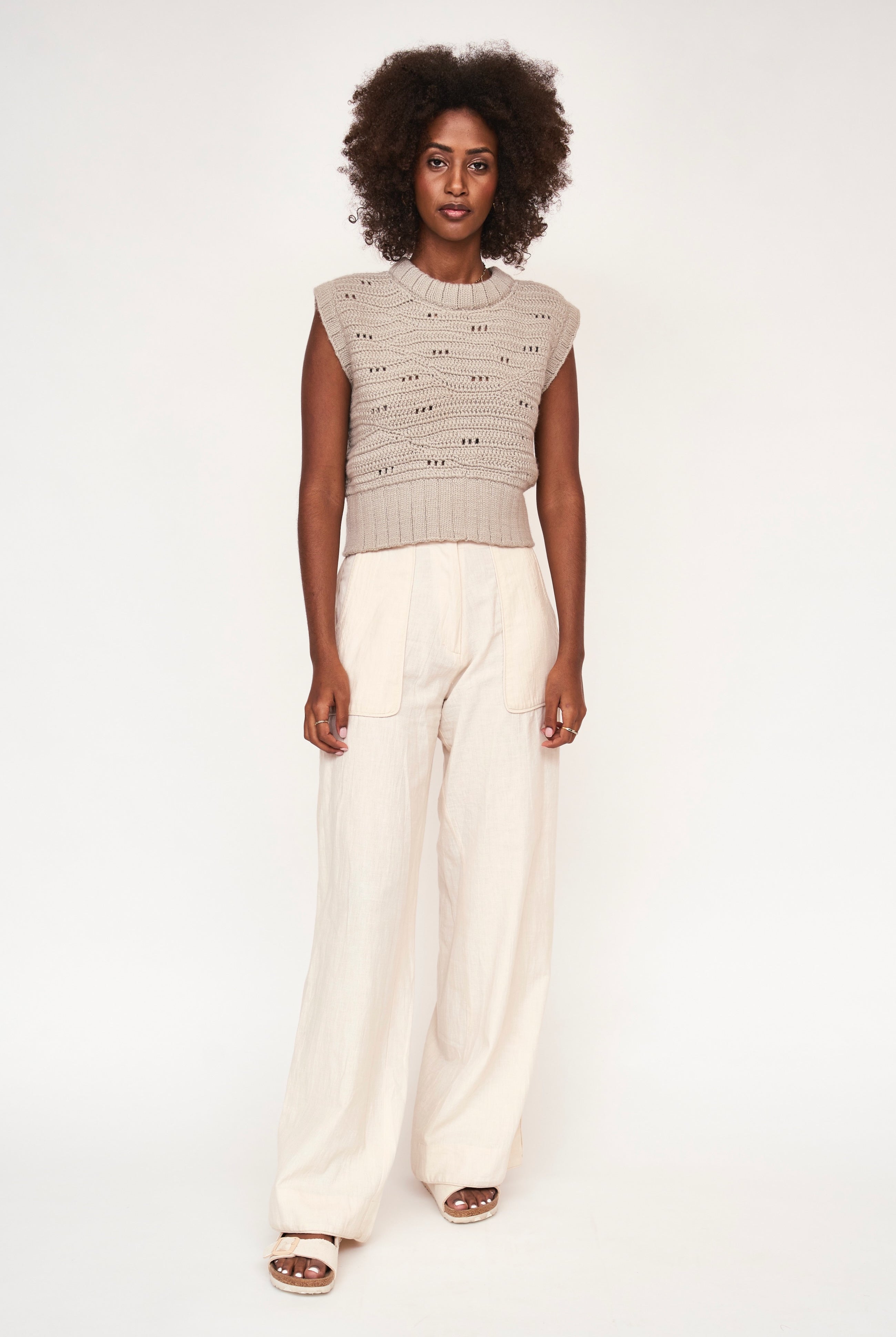 Girl wearing MIRTH women's hand crocheted marin sweater vest in koala grey alpaca wool