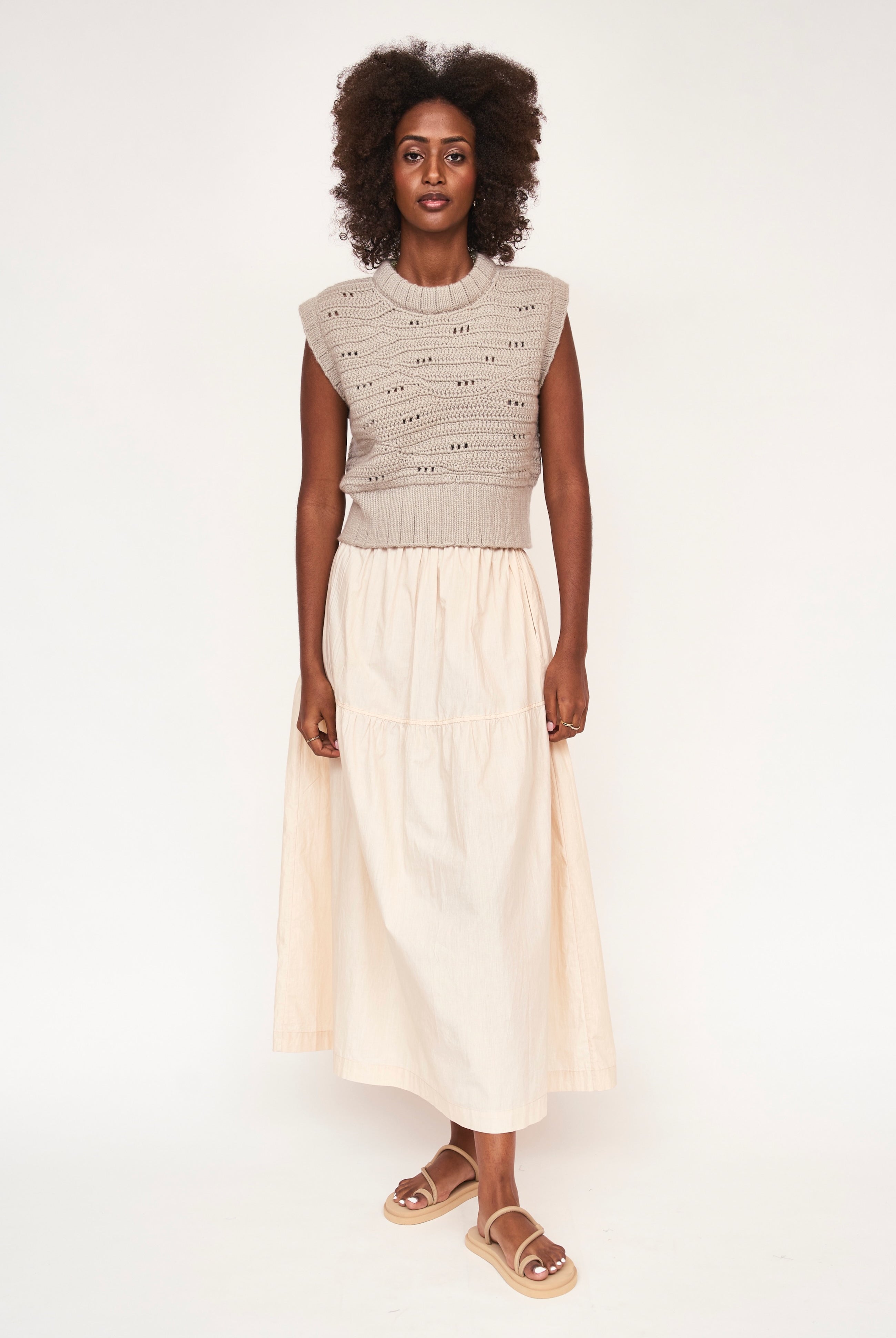 Girl wearing MIRTH women's hand crocheted marin sweater vest in koala grey alpaca wool