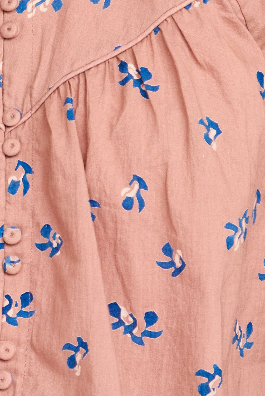 Close-up of a pink garment with blue floral patterns