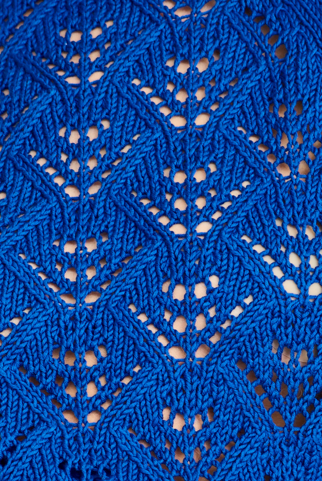 Close-up of blue knitted fabric with a geometric pattern
