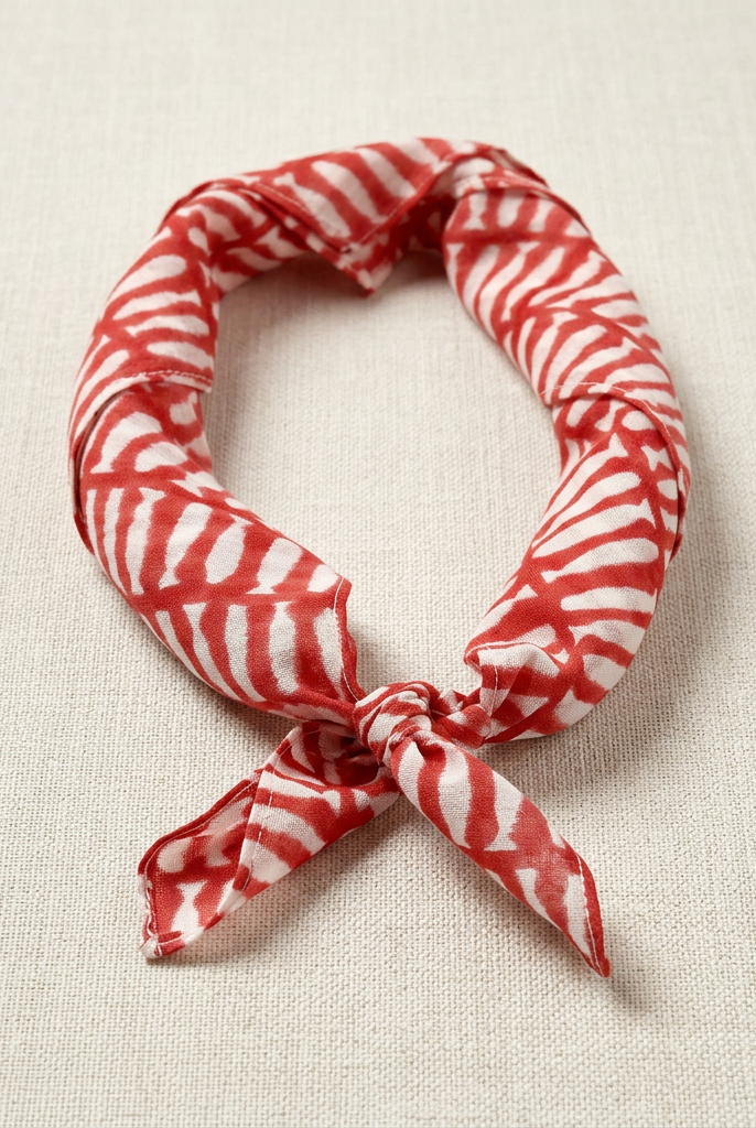 Red and white striped bandana on a beige fabric background