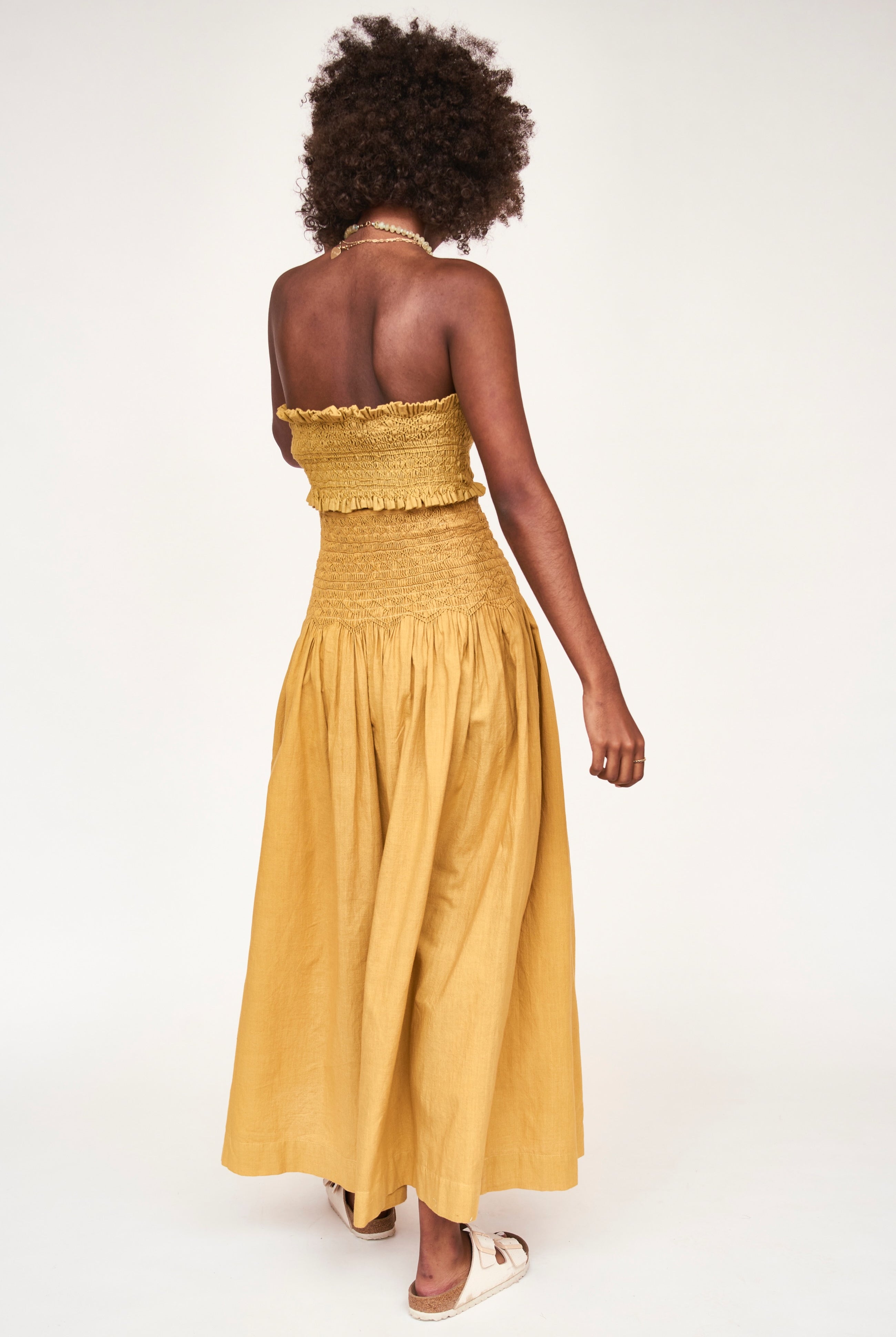 Girl wearing MIRTH women's smocked elastic savannah sleeveless cropped top set in yellow frost cotton