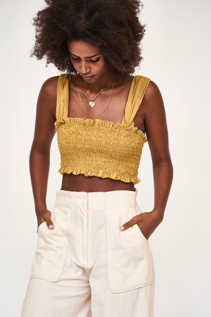 Girl wearing MIRTH women's smocked elastic savannah sleeveless cropped top set in yellow frost cotton