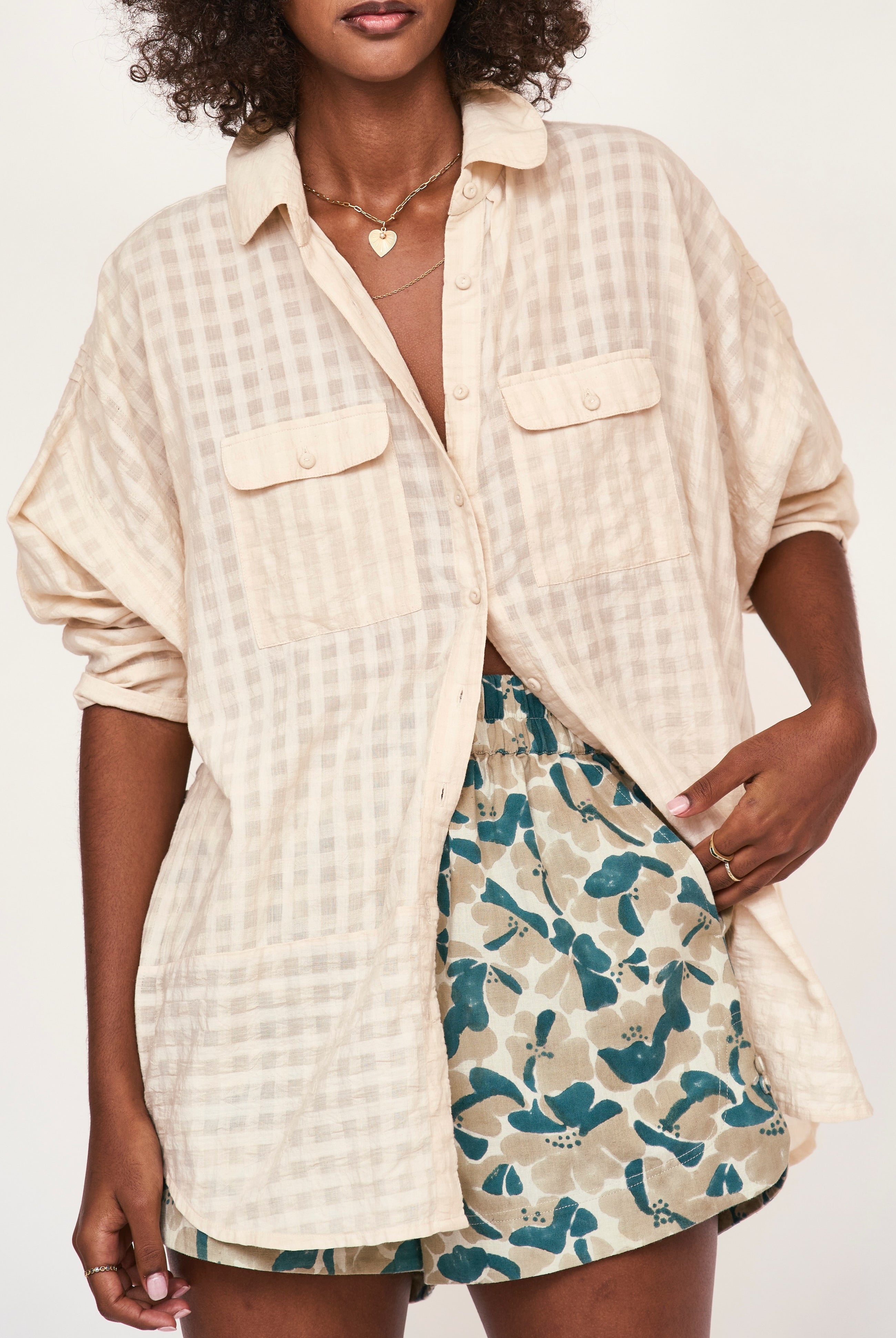 Girl wearing MIRTH women's wide leg elastic track shorts in plumeria blue floral print cotton