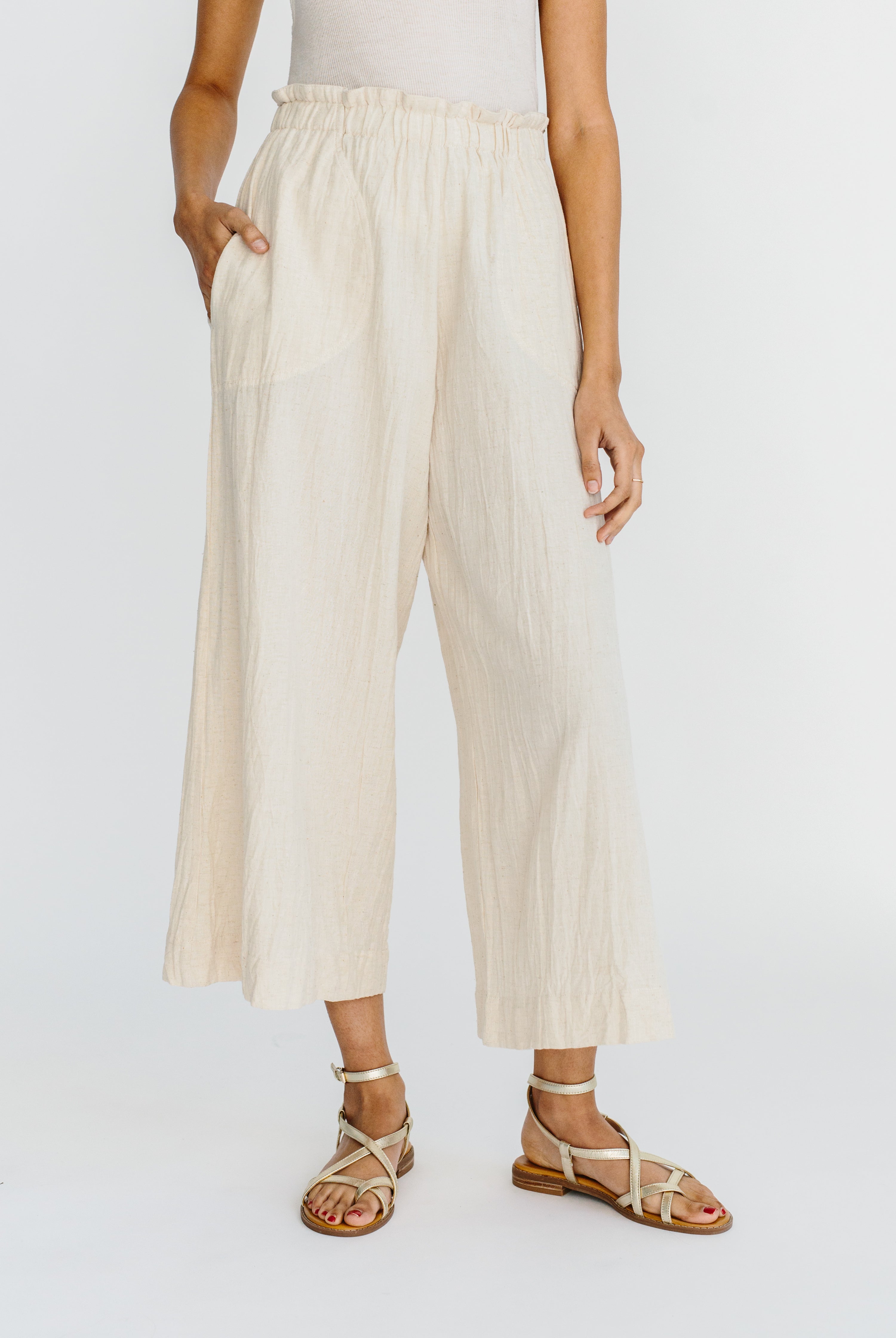 Girl wearing MIRTH women's paperbag waist wide leg palazzo pant in oatmeal beige
