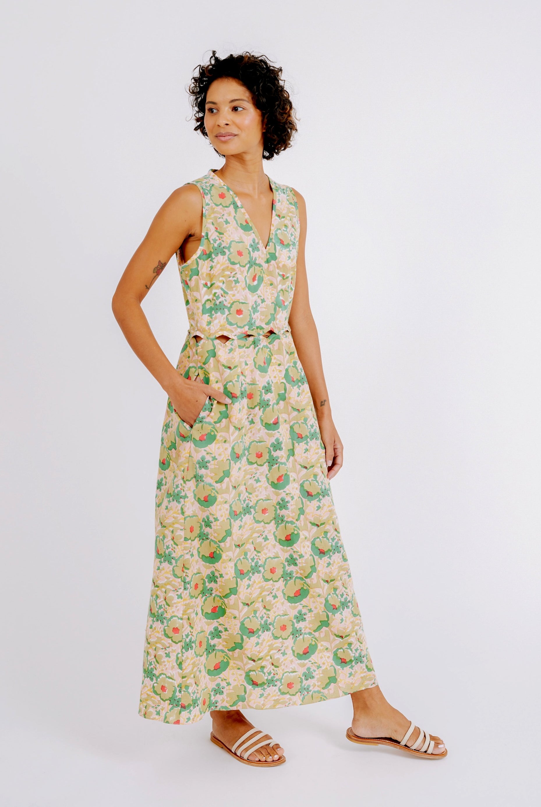 Girl wearing MIRTH women's cotton sleeveless scalloped long biarritz cutout dress in rose bloom pink floral print