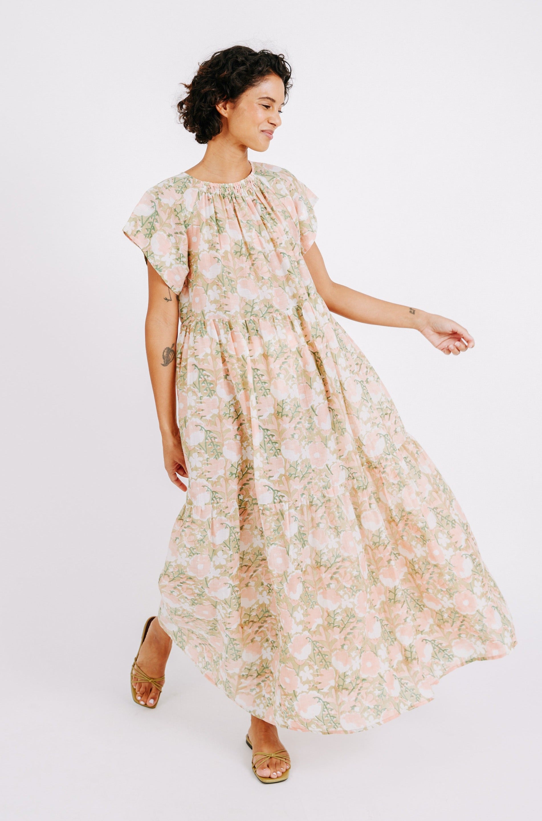 Girl wearing MIRTH women's long tiered short sleeve vienna maxi dress in snapdragon bloom pink floral print cotton