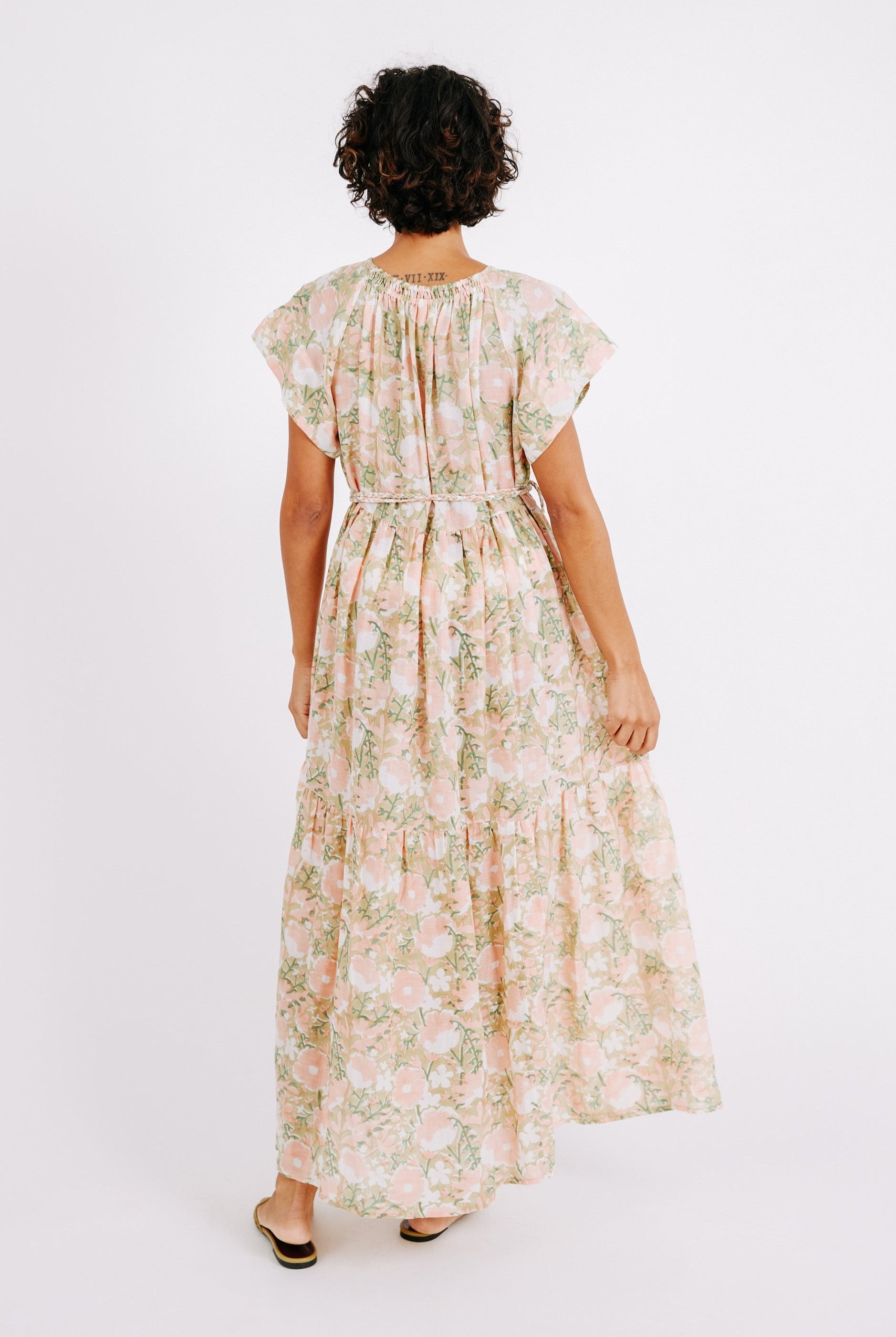 Girl wearing MIRTH women's long tiered short sleeve vienna maxi dress in snapdragon bloom pink floral print cotton