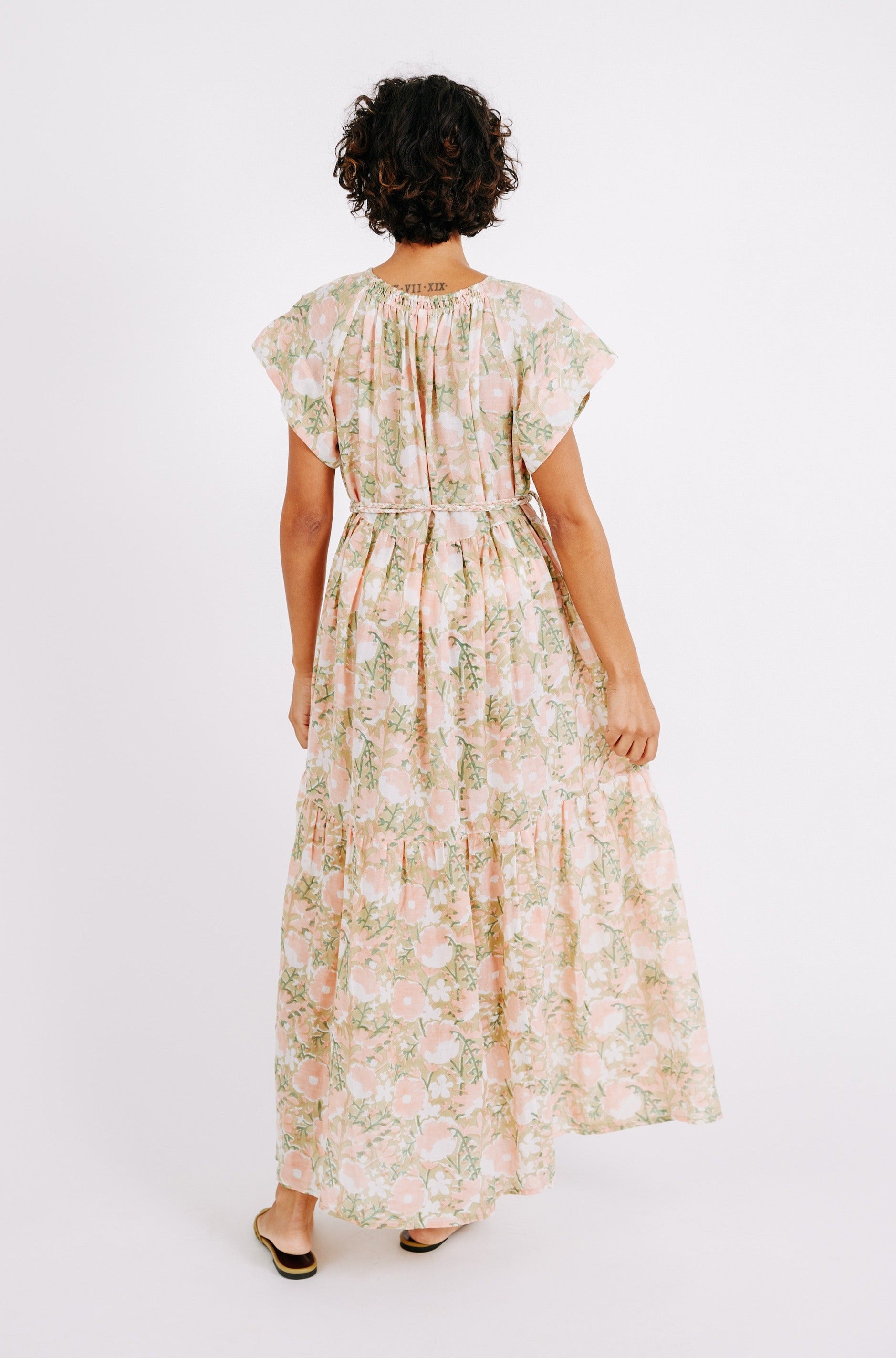 Girl wearing MIRTH women's long tiered short sleeve vienna maxi dress in snapdragon bloom pink floral print cotton