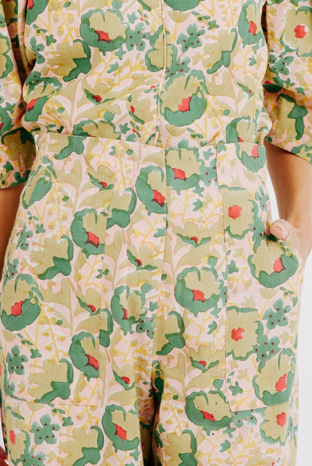 Girl wearing MIRTH women's high waist zip closure cotton tivot pant in rose bloom pink floral print