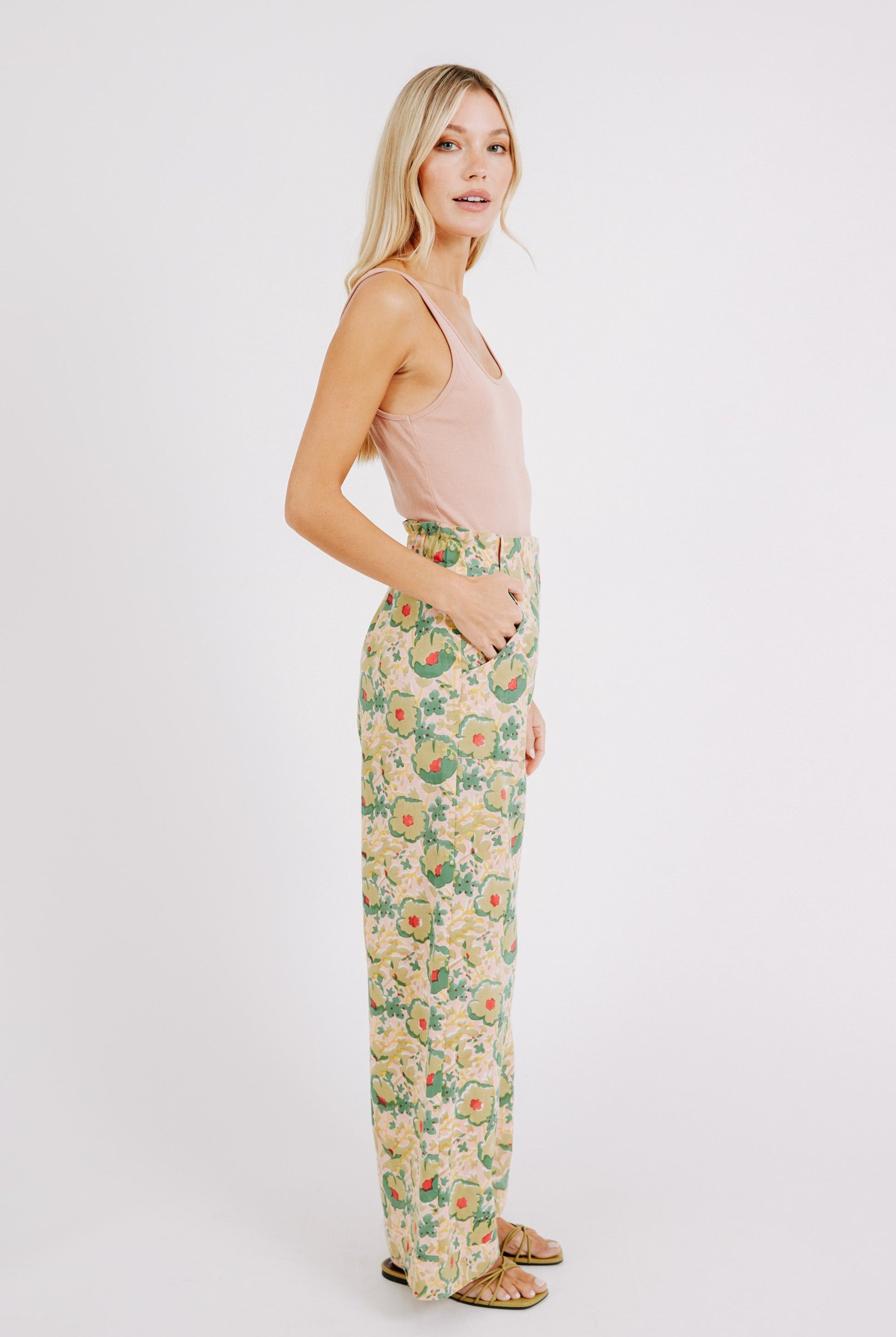 Girl wearing MIRTH women's high waist zip closure cotton tivot pant in rose bloom pink floral print