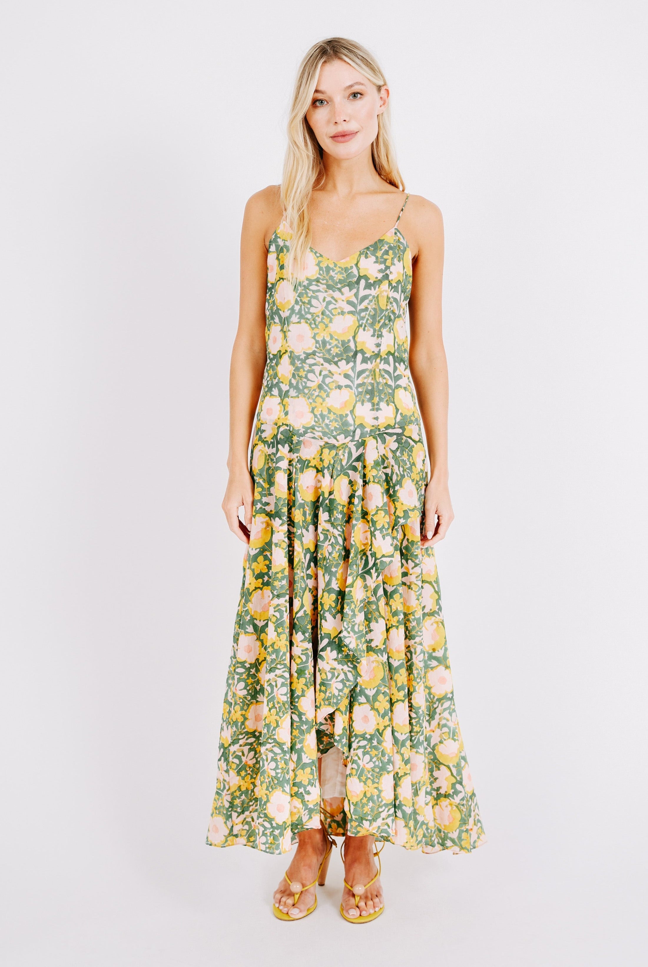 Girl wearing MIRTH women's long singapore spaghetti strap drop waist dress in camelia bloom green floral print cotton