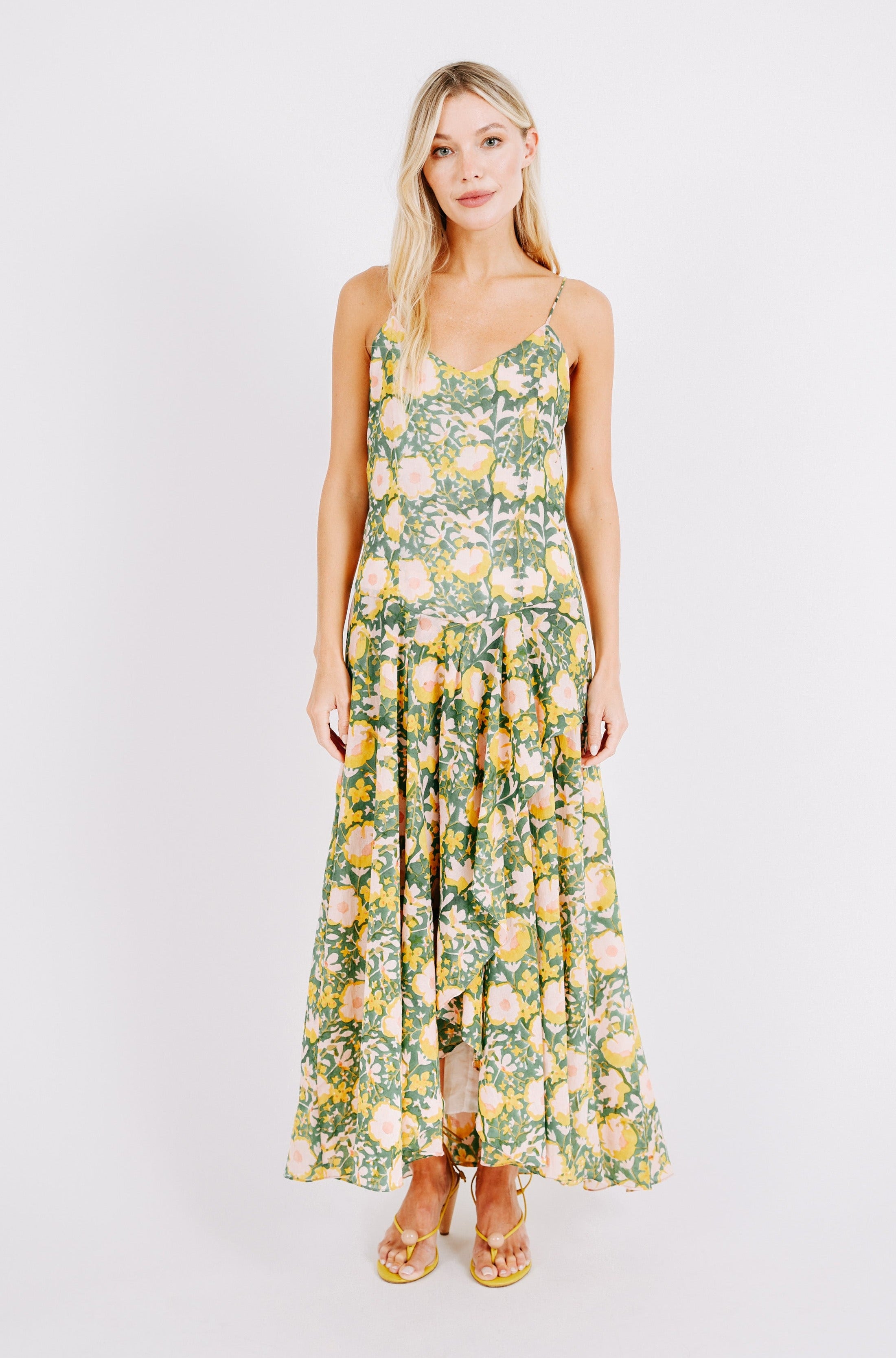 Girl wearing MIRTH women's long singapore spaghetti strap drop waist dress in camelia bloom green floral print cotton