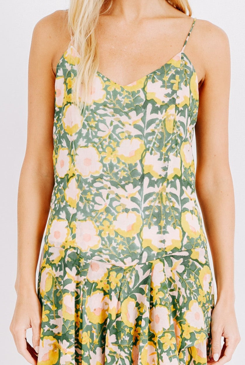 Girl wearing MIRTH women's long singapore spaghetti strap drop waist dress in camelia bloom green floral print cotton