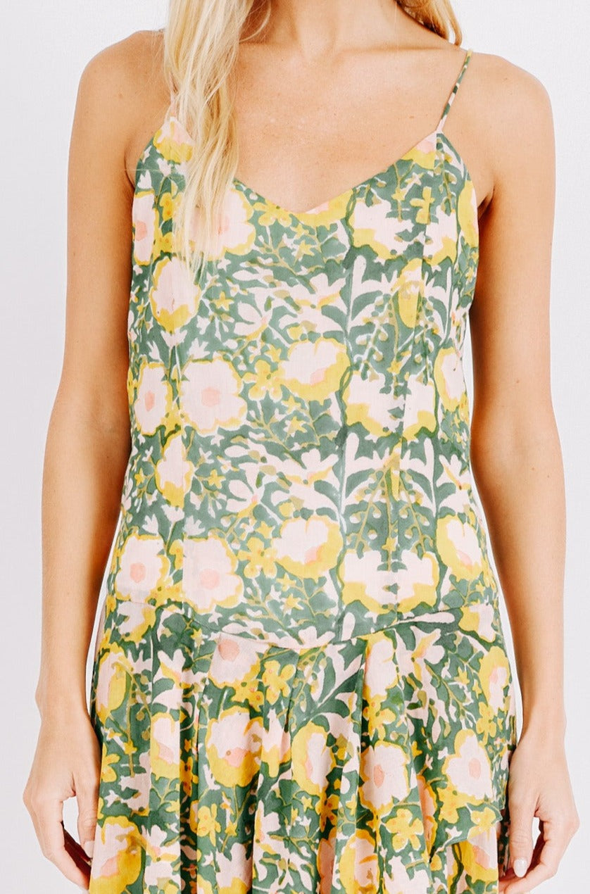 Girl wearing MIRTH women's long singapore spaghetti strap drop waist dress in camelia bloom green floral print cotton