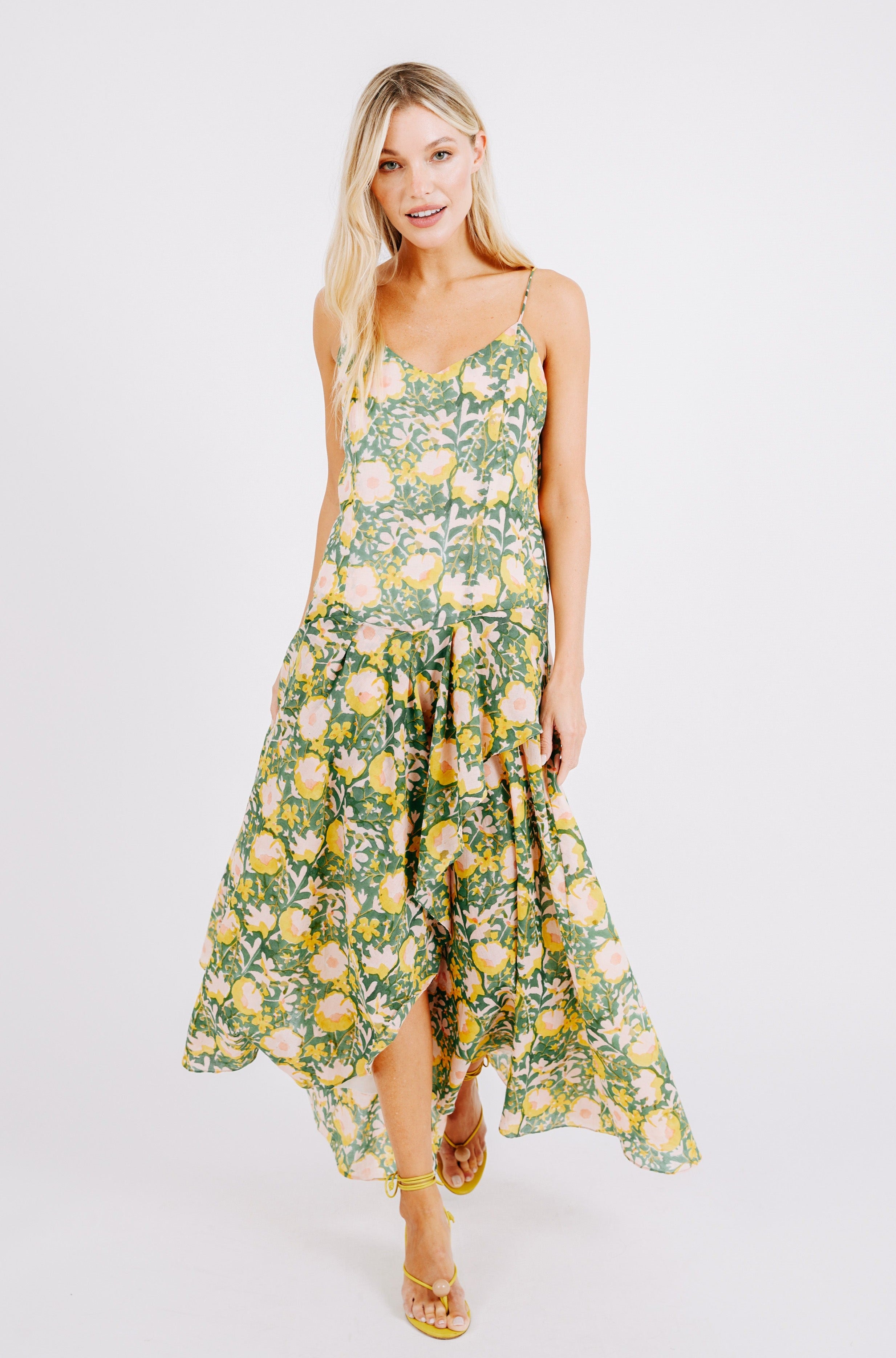 Girl wearing MIRTH women's long singapore spaghetti strap drop waist dress in camelia bloom green floral print cotton
