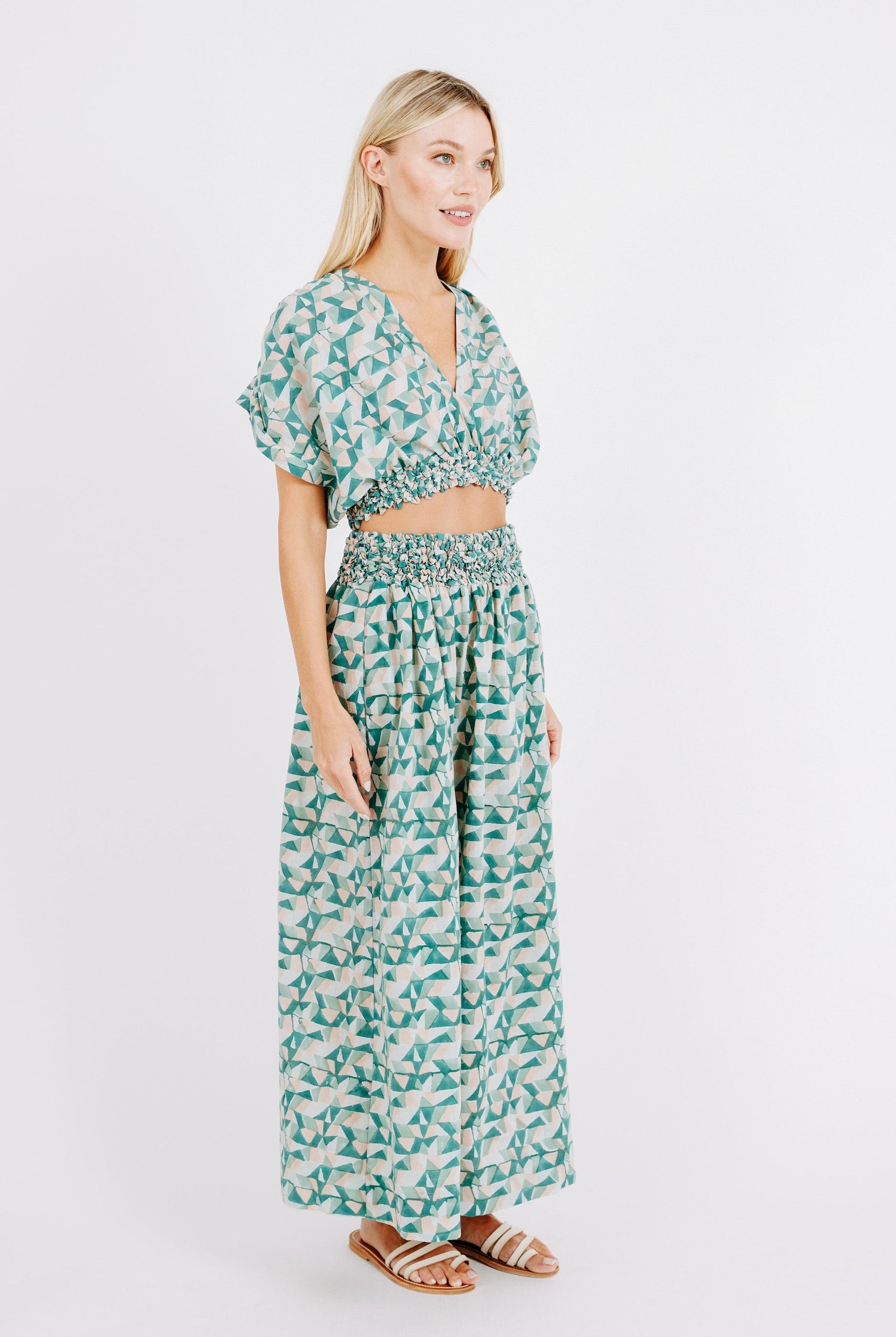 Girl wearing MIRTH women's smocked elastic waist cropped granada top set in seaglass green